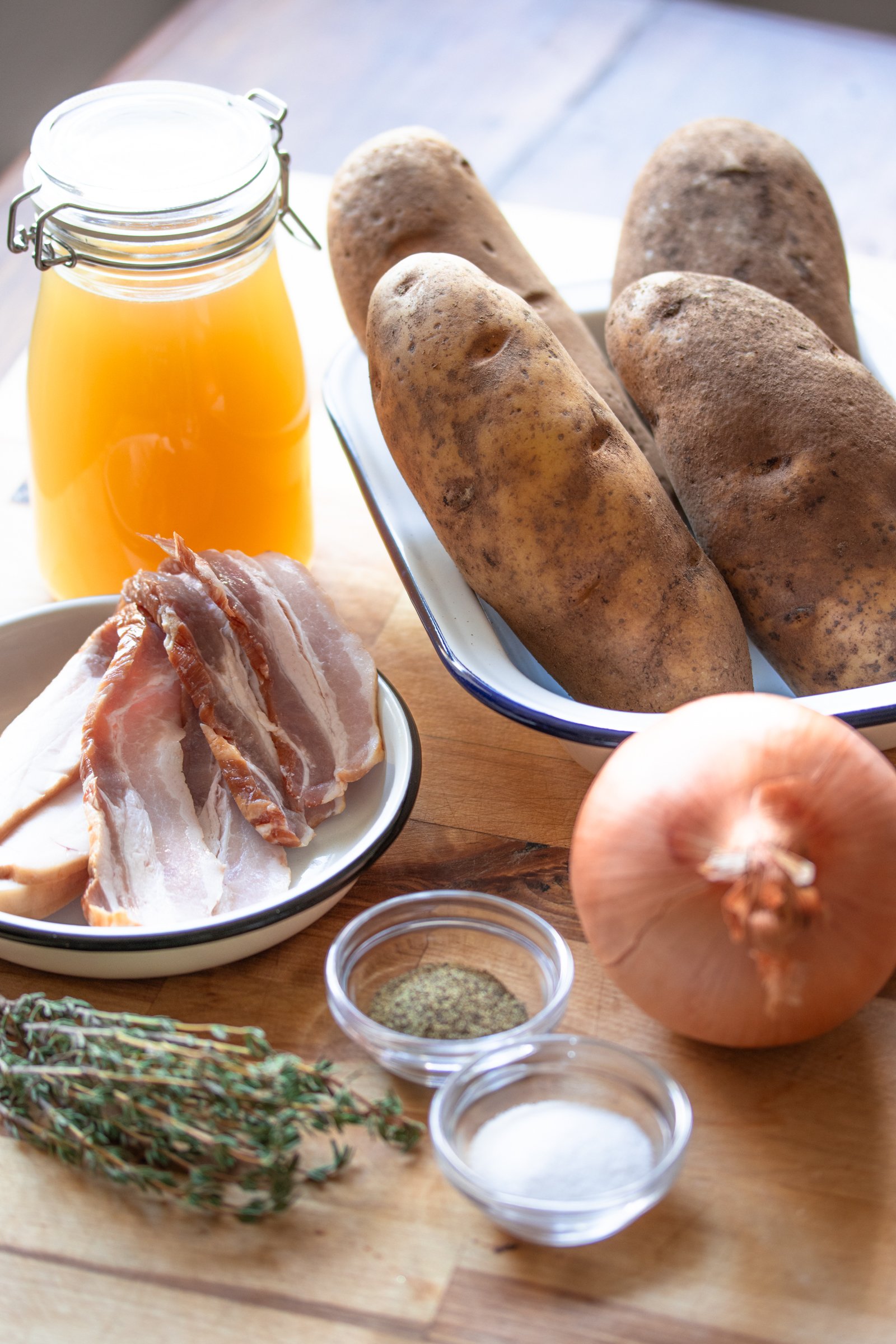 Potatoes Boulangere ingredients: potatoes, bacon, stocl, onion, thyme salt and pepper