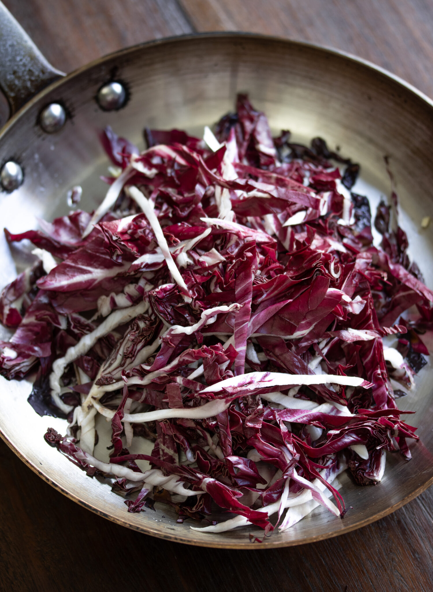 Radicchio slivers placed in the skillet to be cooked.