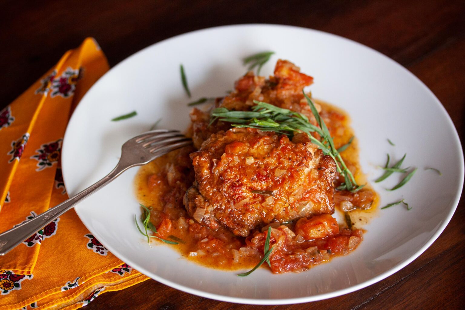 tarragon chicken on a white serving plate
