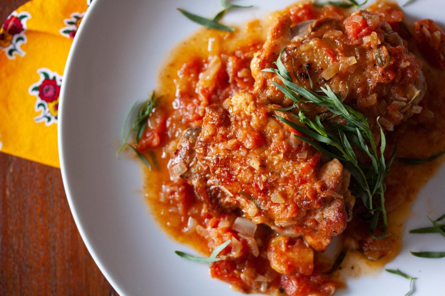 tarragon chicken served on a white plate