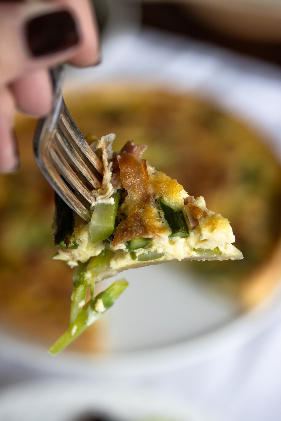 a bite of asparagus on a fork