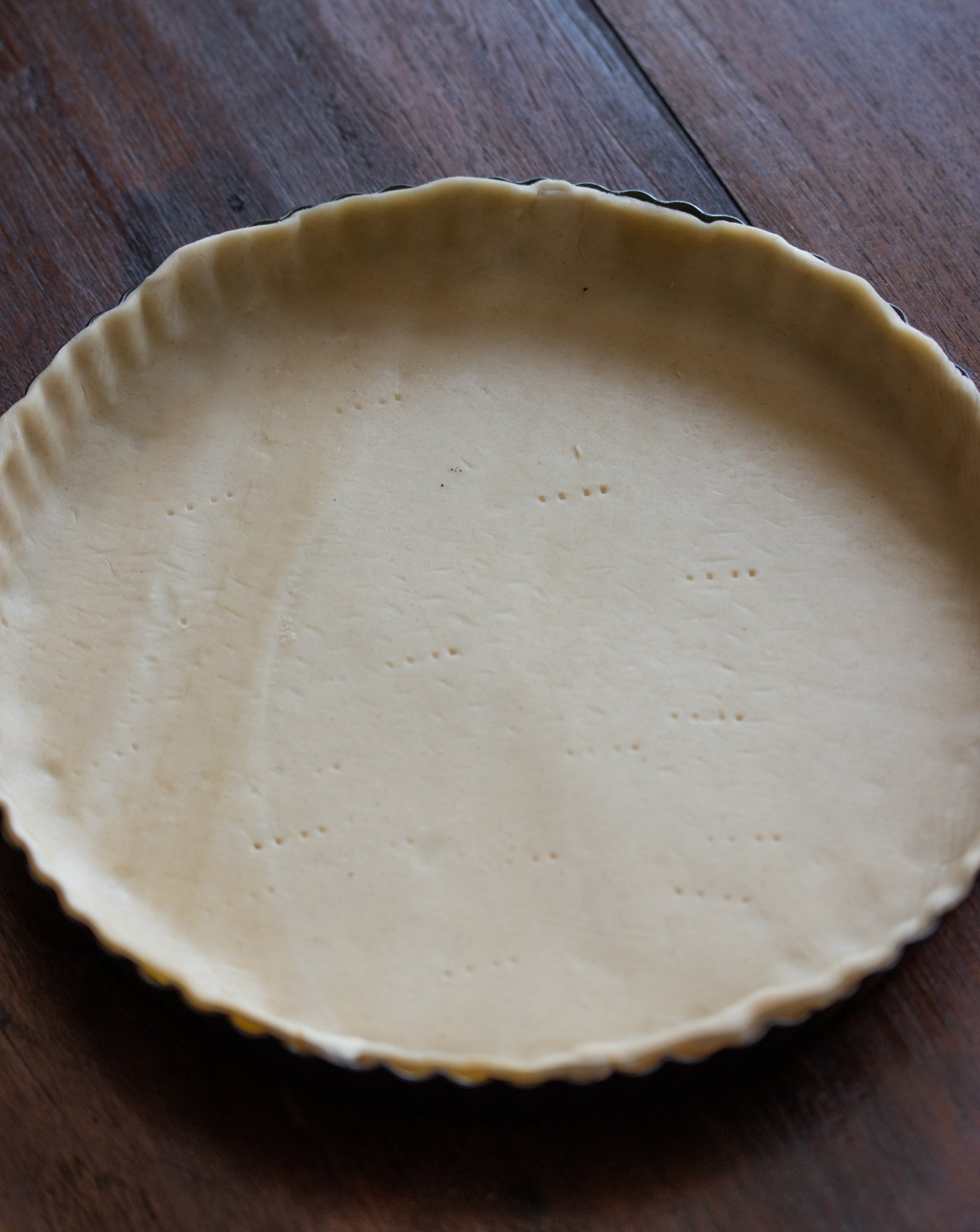 Asparagus ham quiche pie dough prior to going in the oven and with pie weights