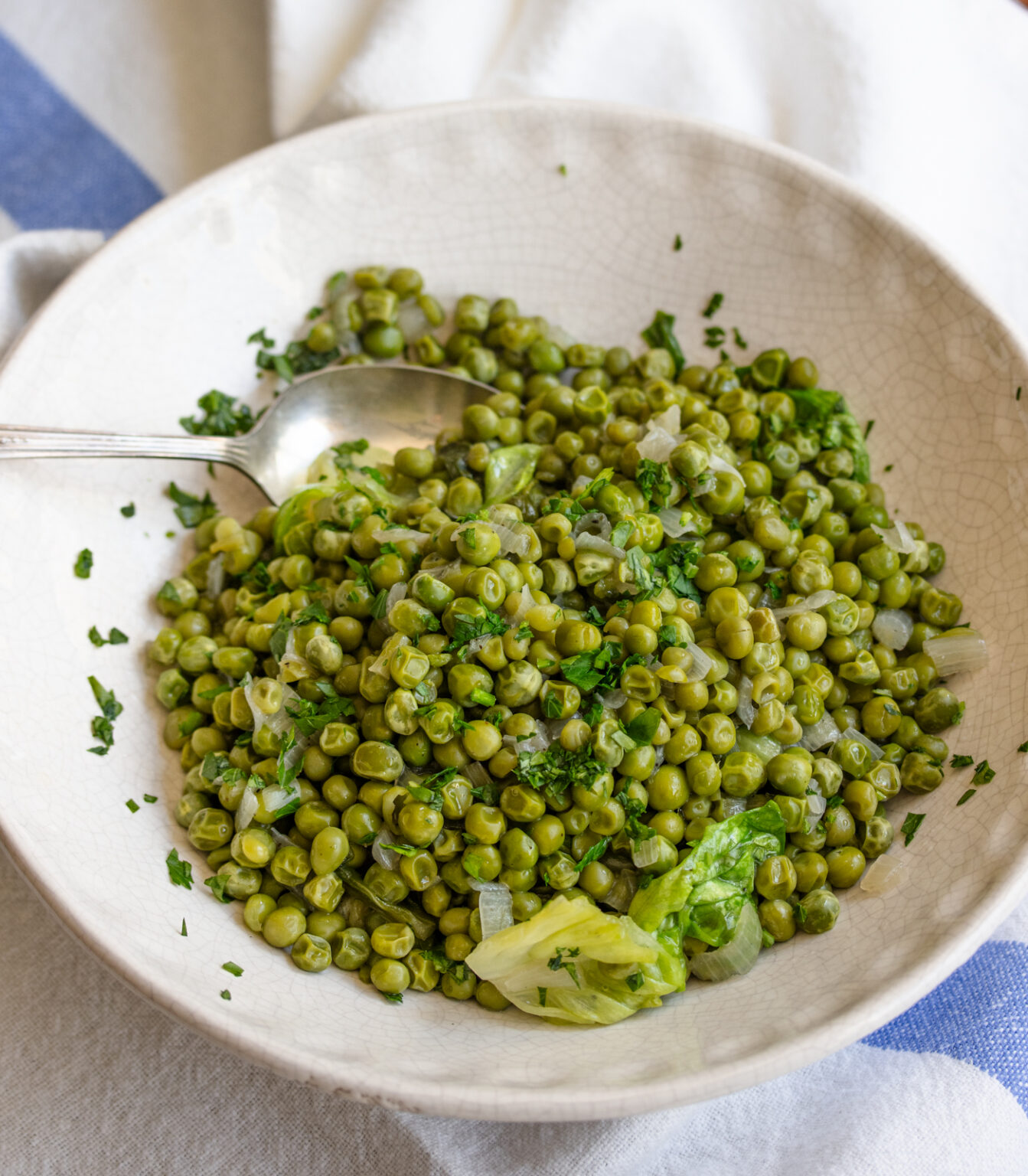 Petits Pois A La Francaise in a serving dish with spoon