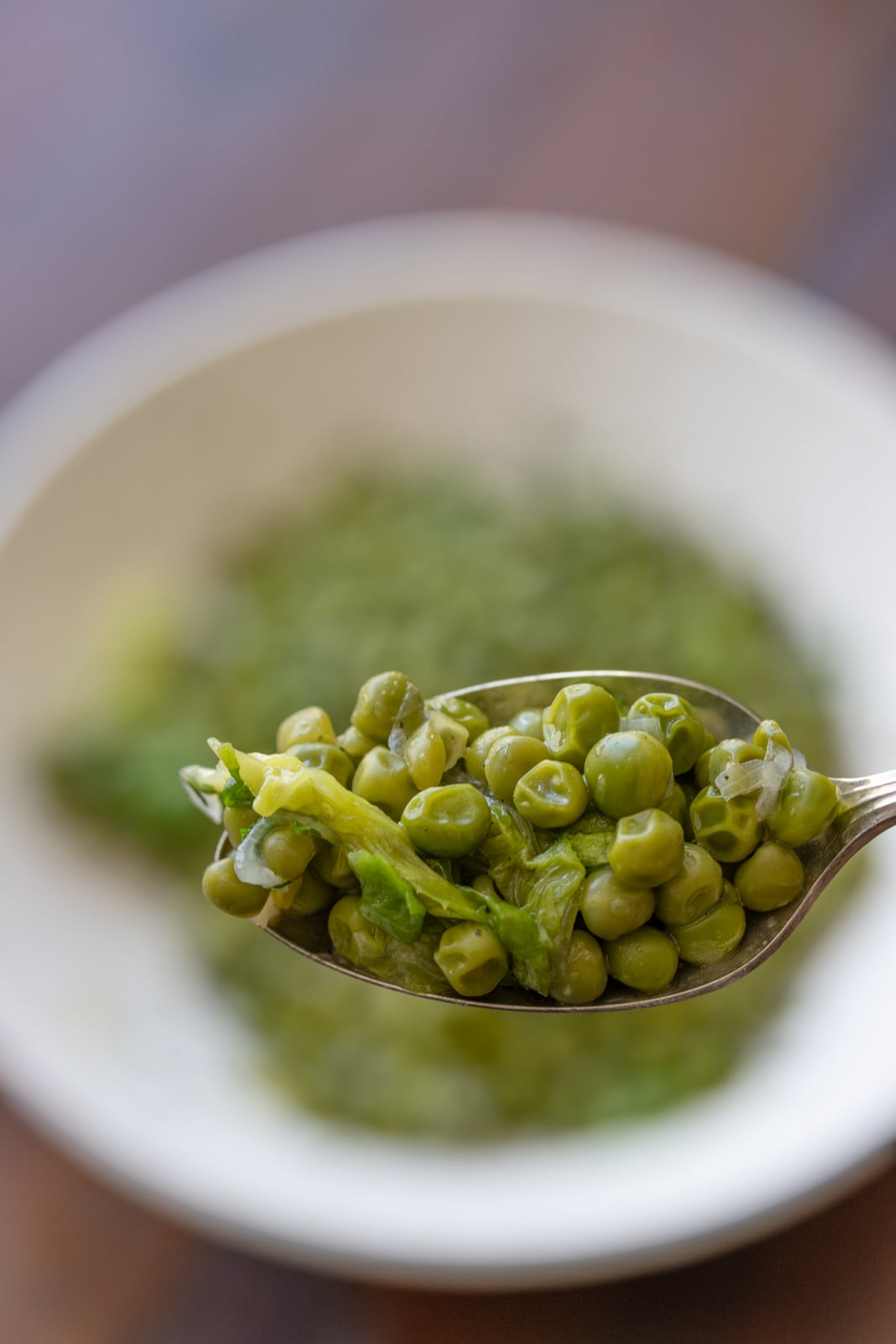 French peas on a spoon close up view.