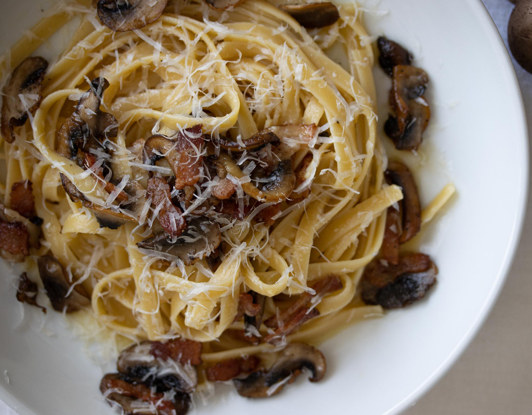 linguine past with bacon and mushroom on a serving plate