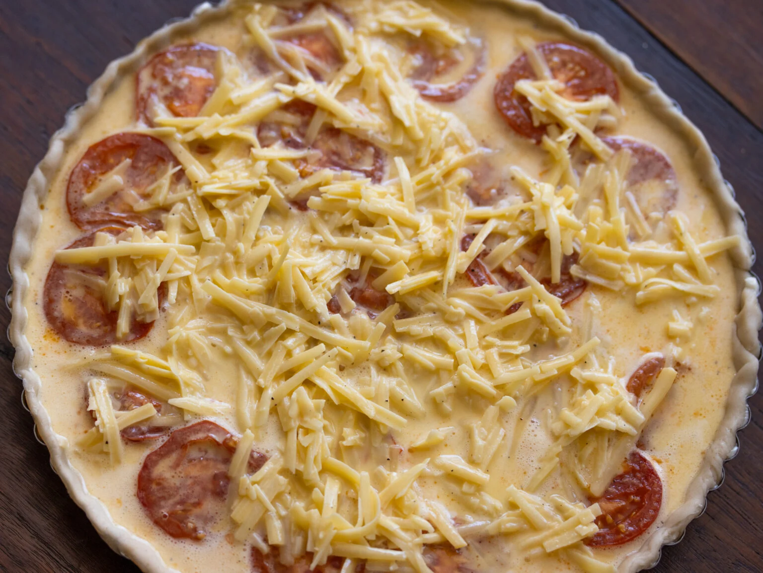 egg mixture with cheese over the tomatoes