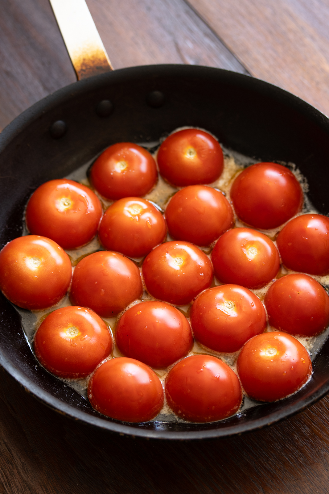 Tomatoes in a skillet cut side down