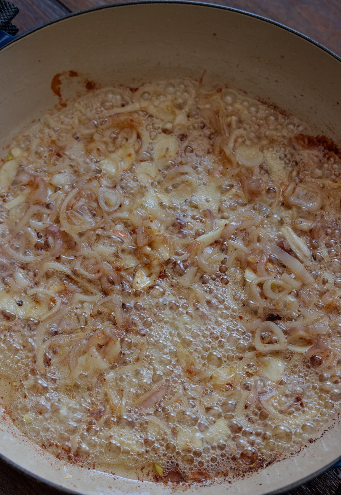 Chciken broth added to dislodge the brown bits from the chicken to the bottom of the pan.