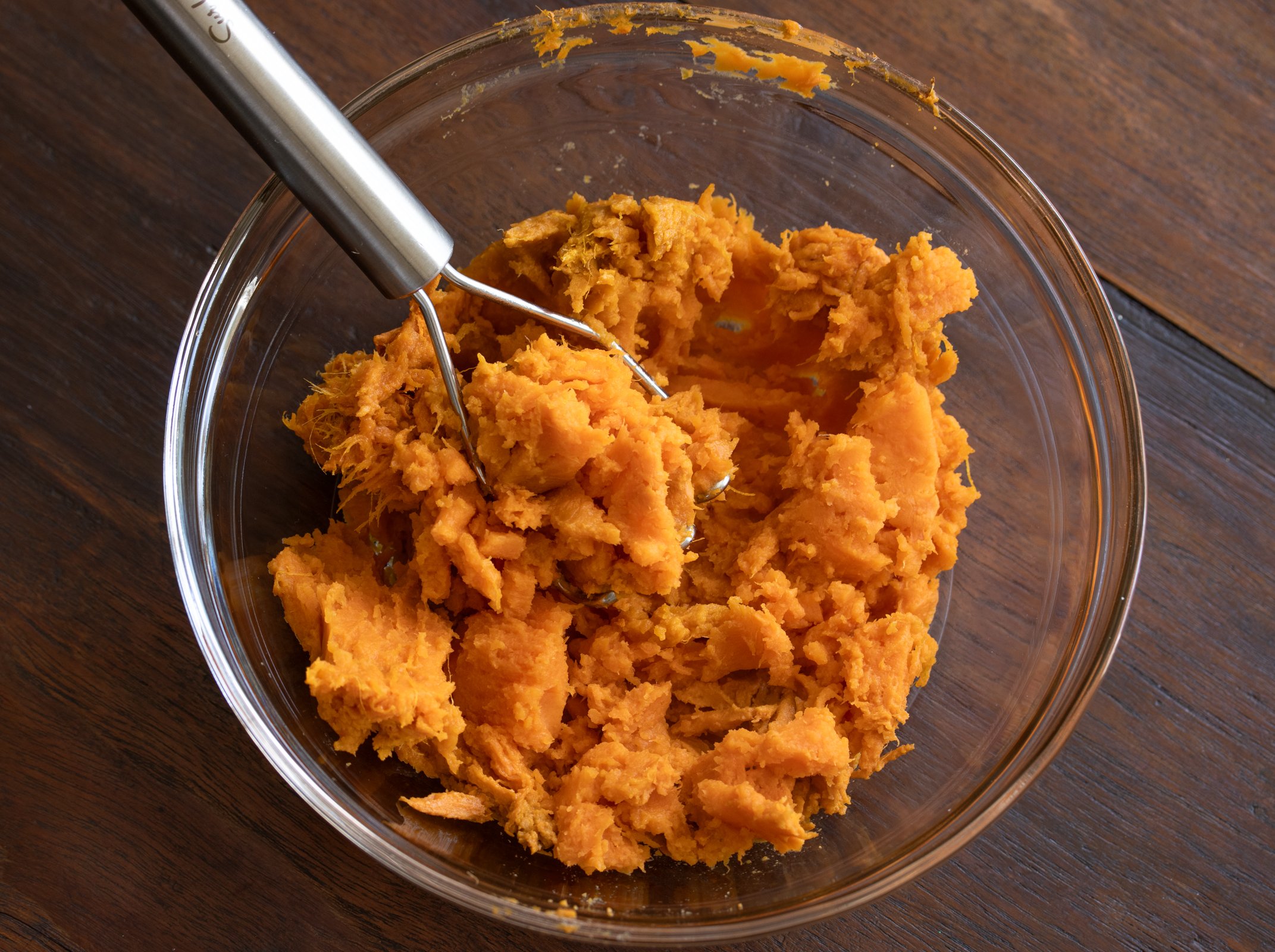 Smashed sweet potato in a bowl.