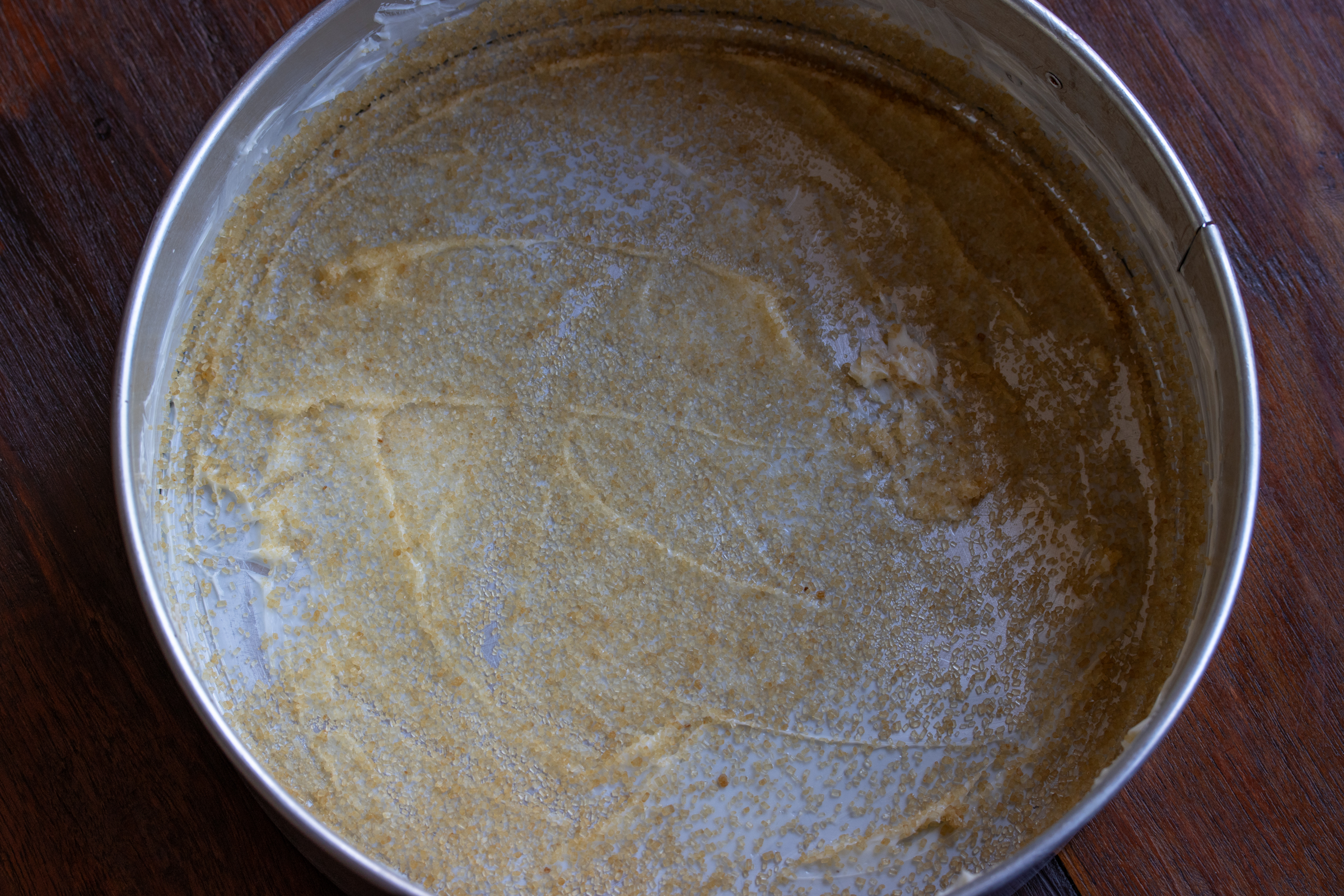 buttered springform mold and turbinado sugar sprinkled over it