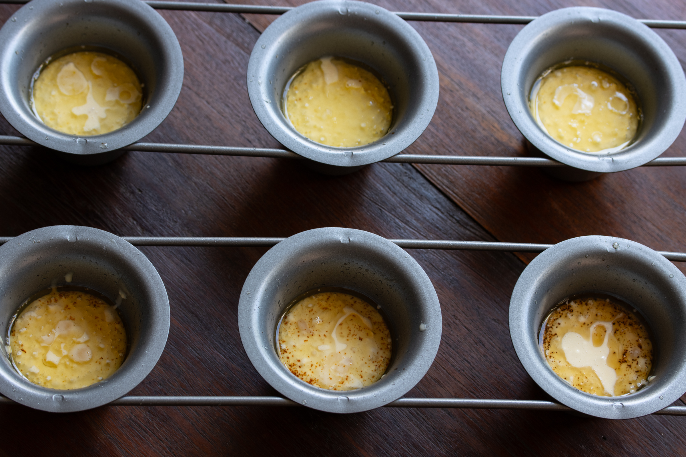 popovers batter in the mold ready to be placed in the hot oven