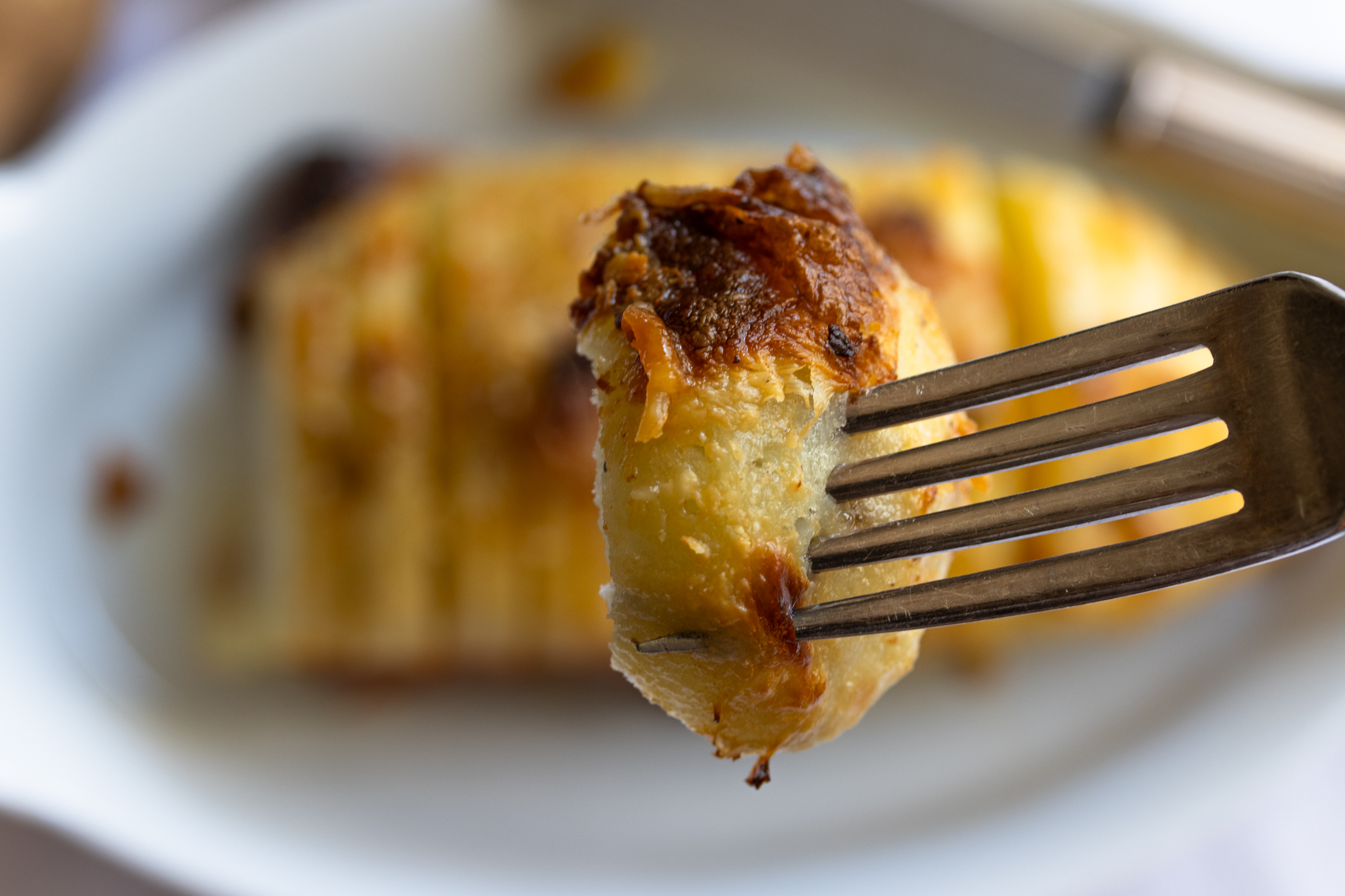 Potatoes Cooked In Milk  in a small serving bite on a spoon
