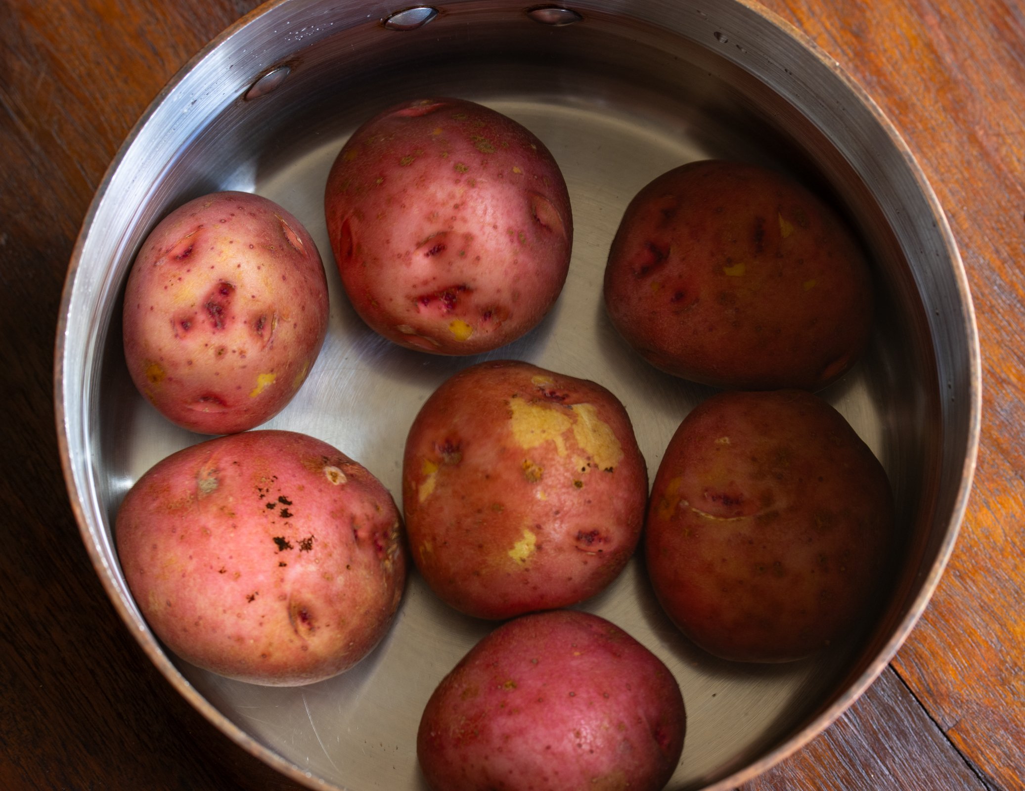 potatoes in water for warm potato salad 