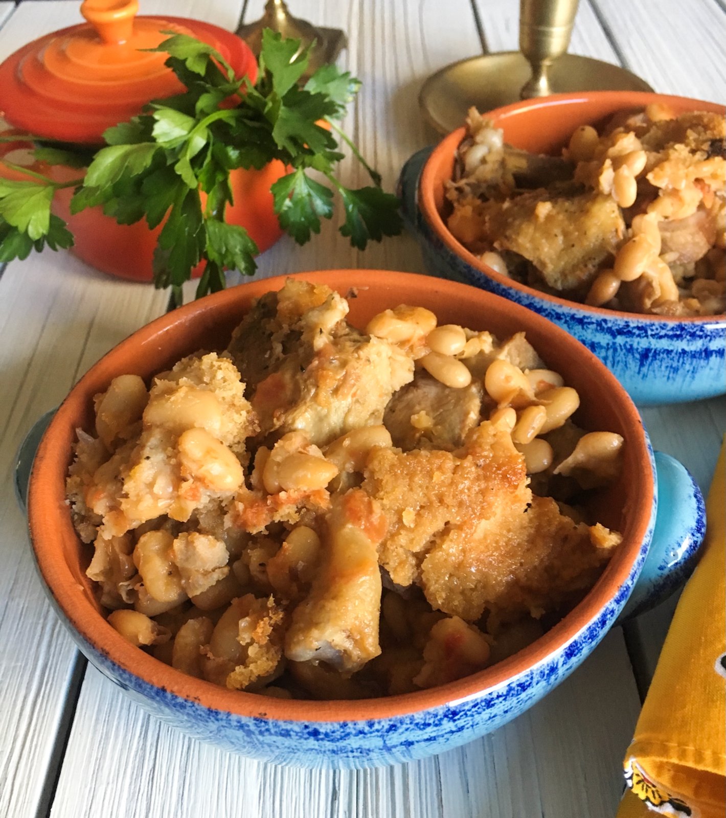 duck cassoulet into serving dishes