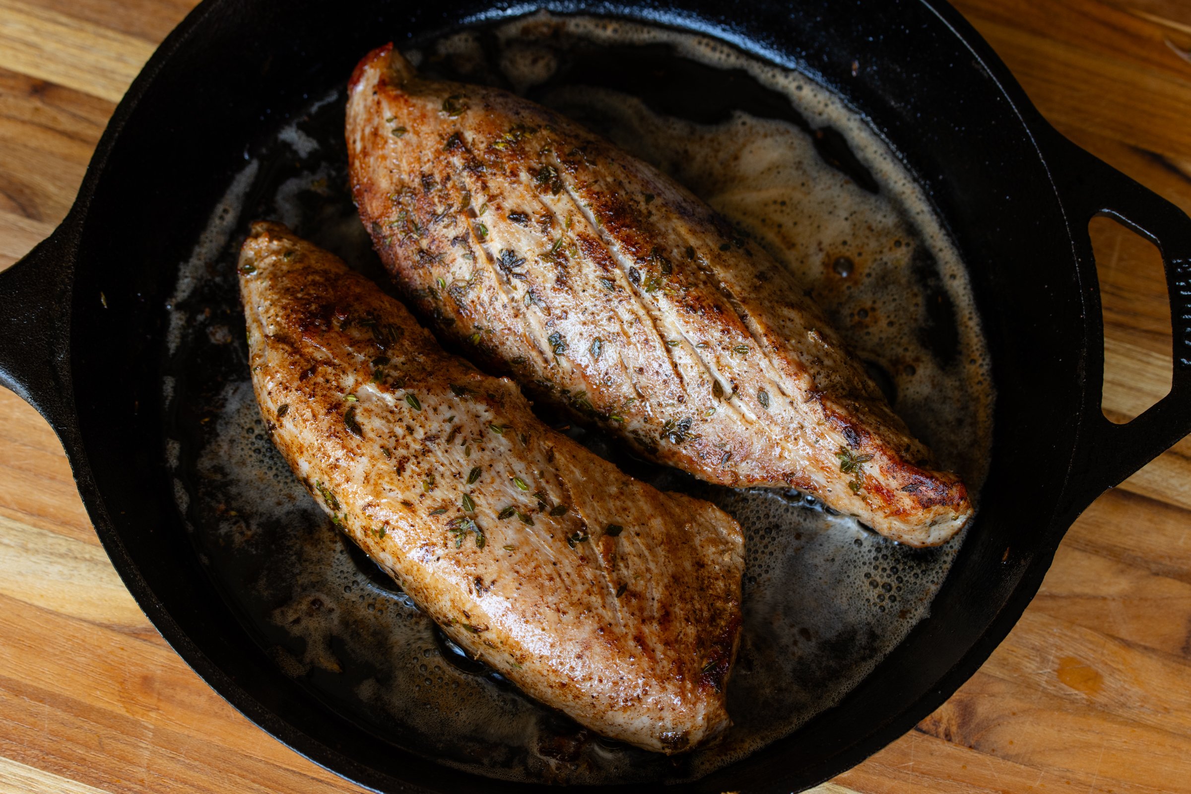 The tenderloin seared in the pan.