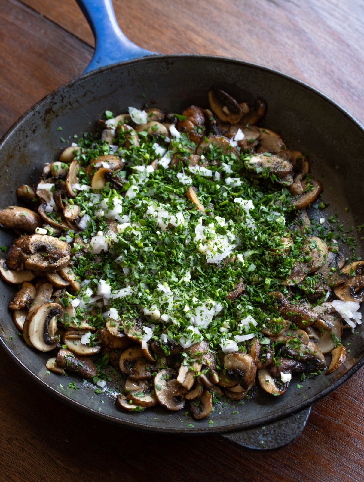mushrooms with garlic, shallots, parsley in the skillet