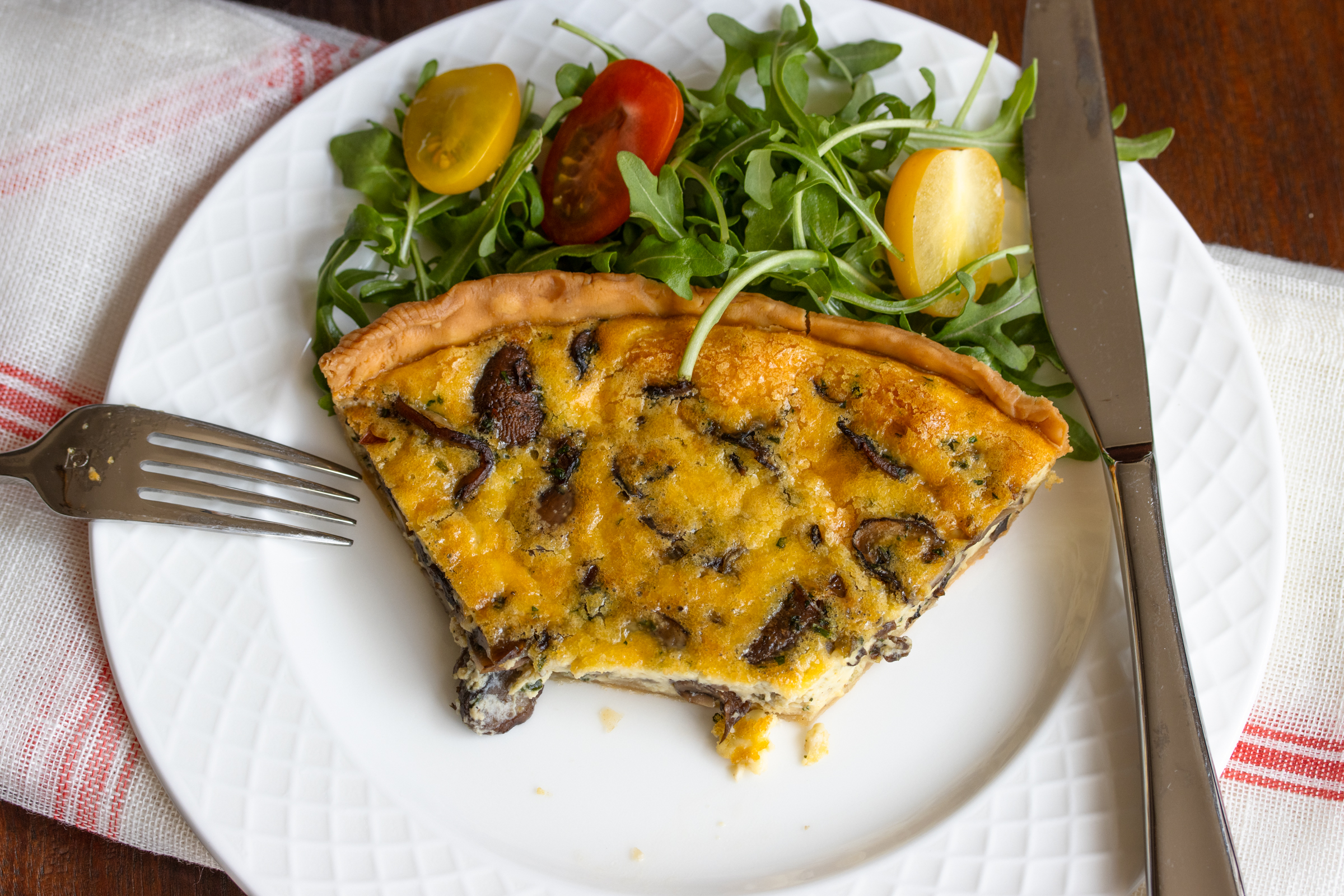 quiche in a white serving plate.