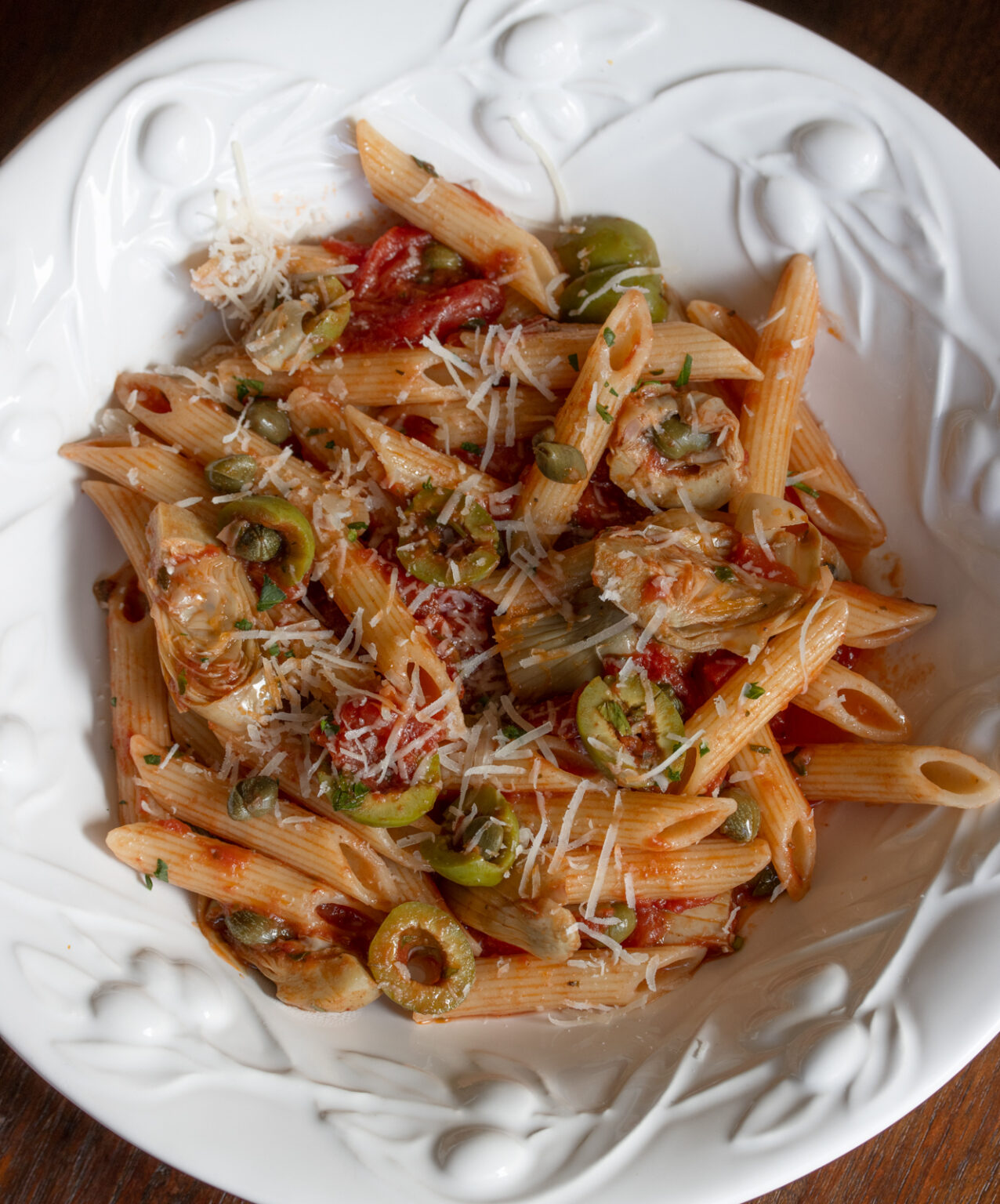 penne pasta with tomatoes sauce served in a white dish