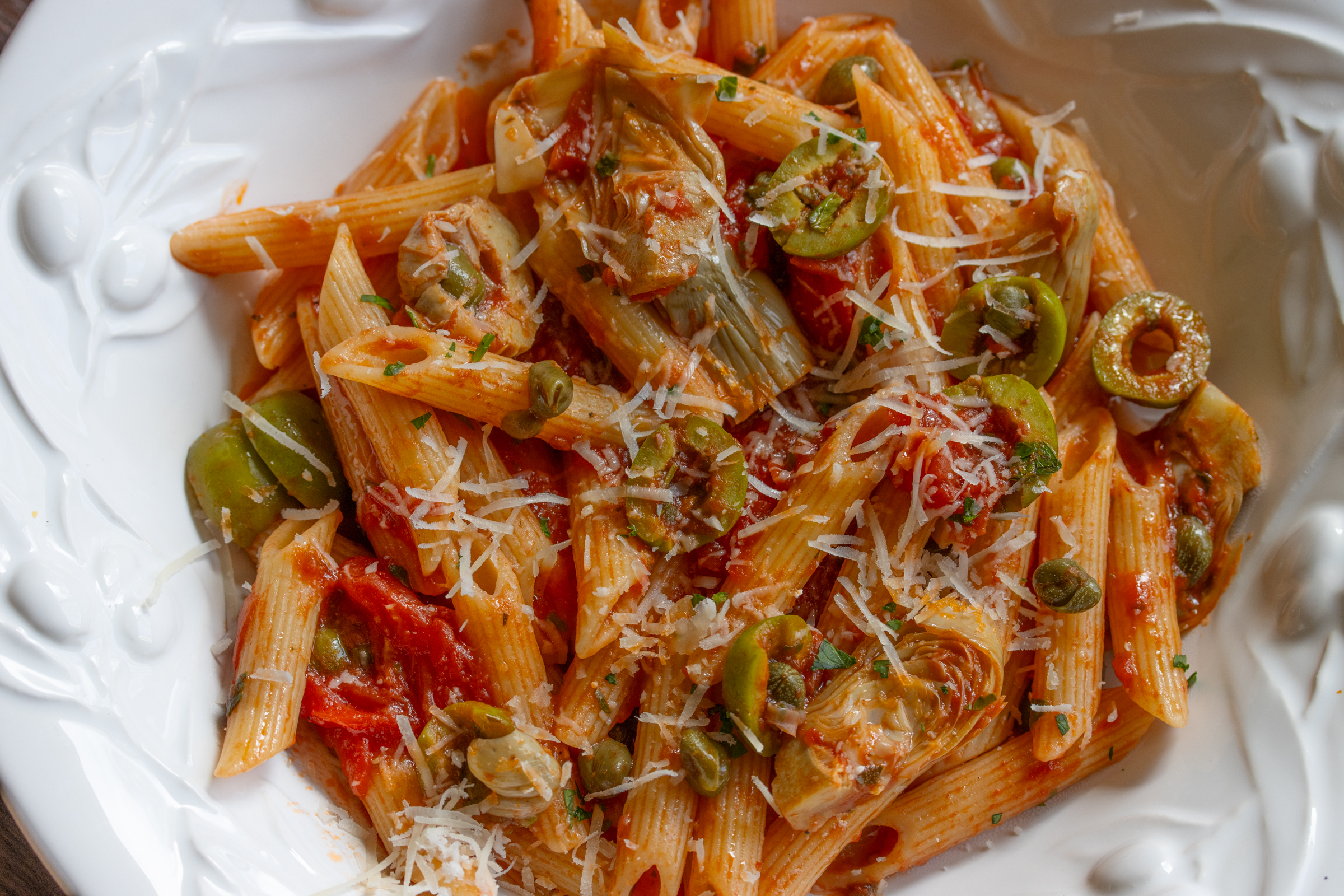 penne pasta with tomatoes, olives and artichokes