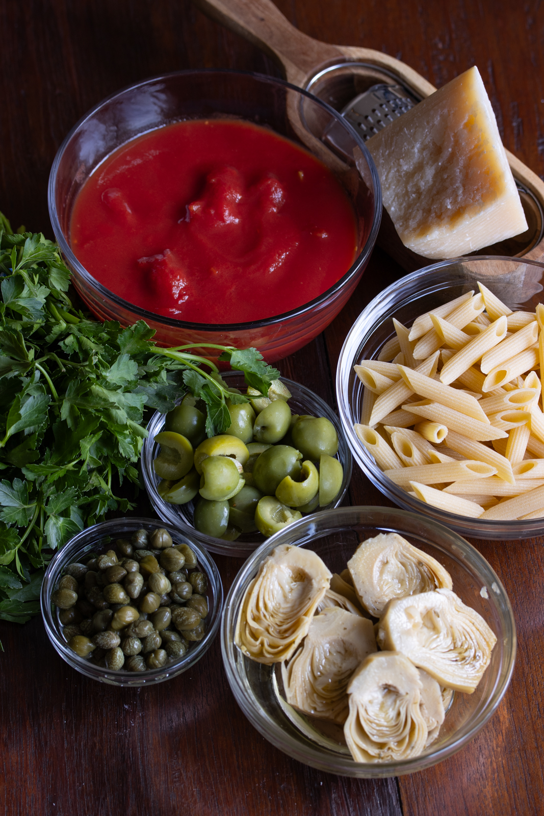 ingredients for penne with tomatoes, olives, and artichokes