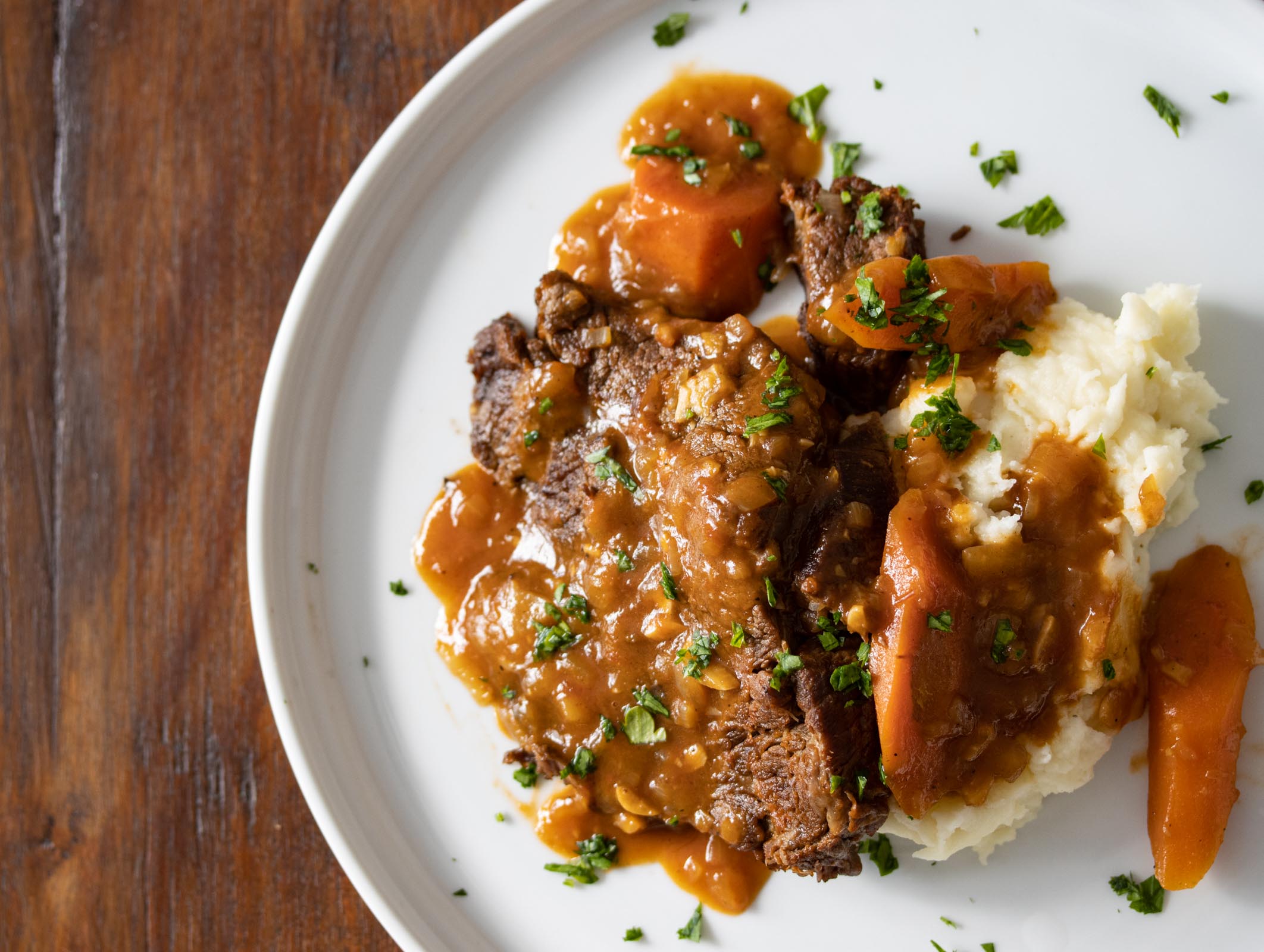 pot roast served on a white plate