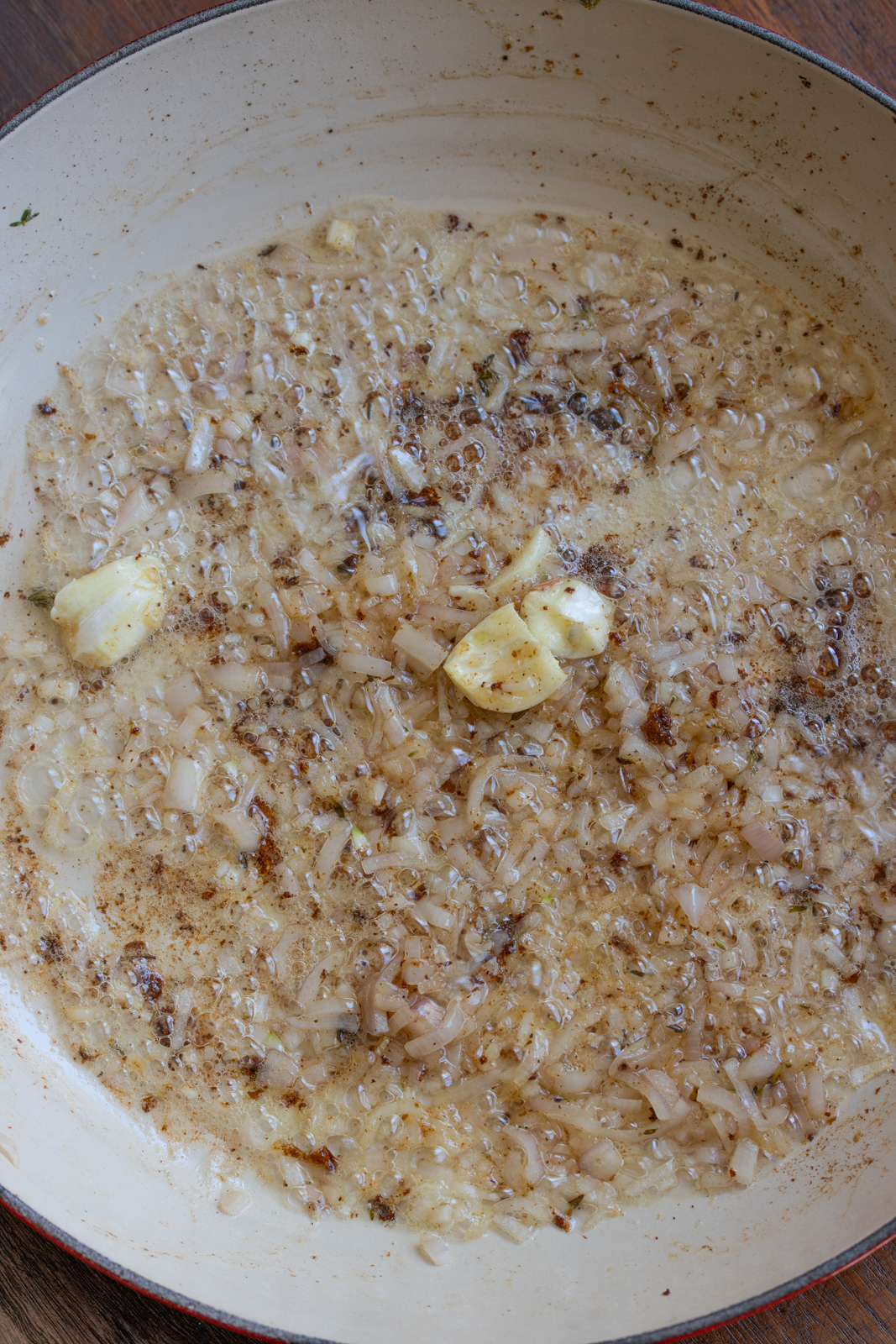 garlic and shallots are added to the skillet