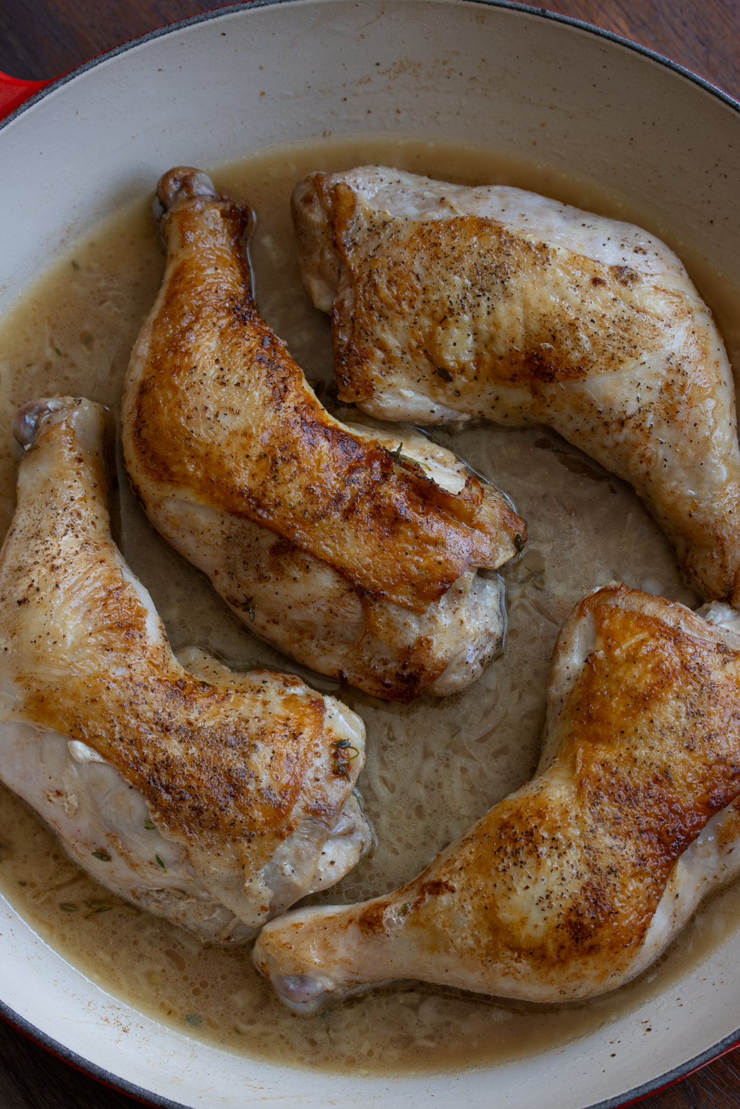 chicken back to the skillet and broth added