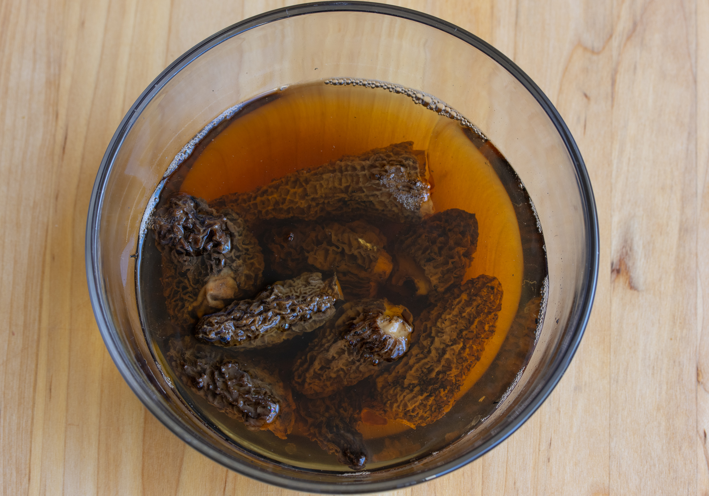 dry morels being rehydrated in warm water.
