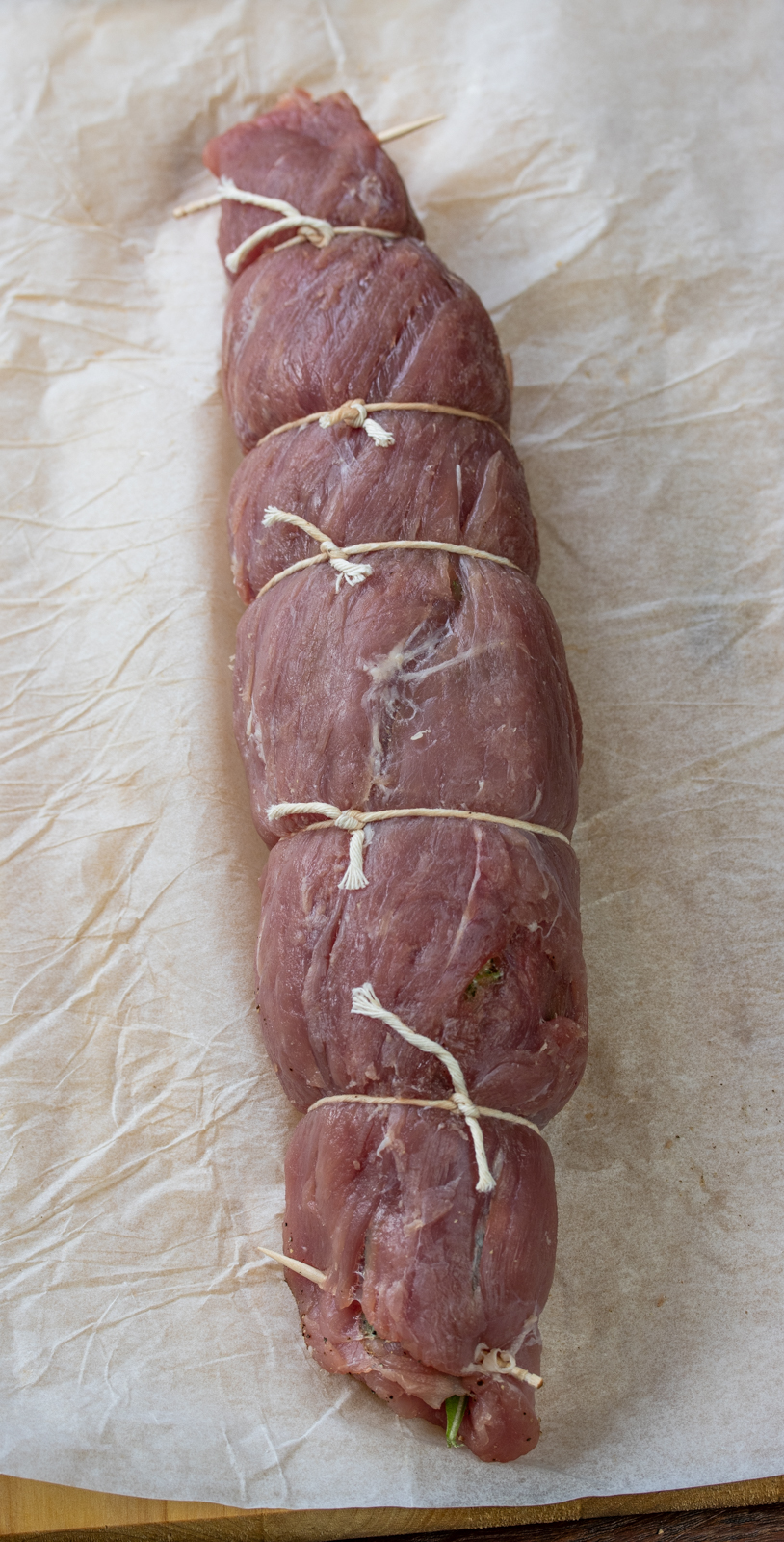 pork tenderloin rolled up and tied with cooking twine