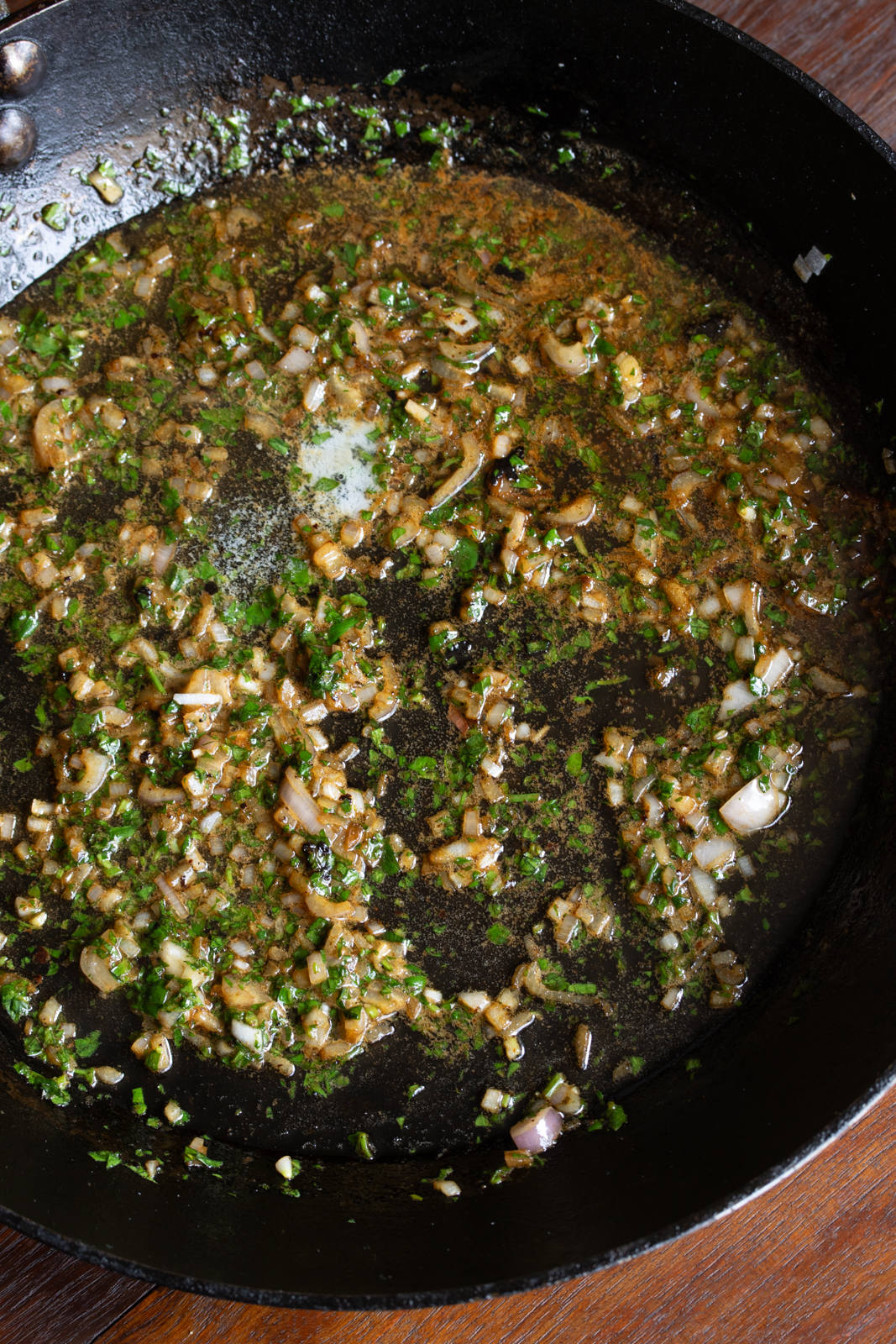 deglazing pan and adding shallots and parsley to create the sauce