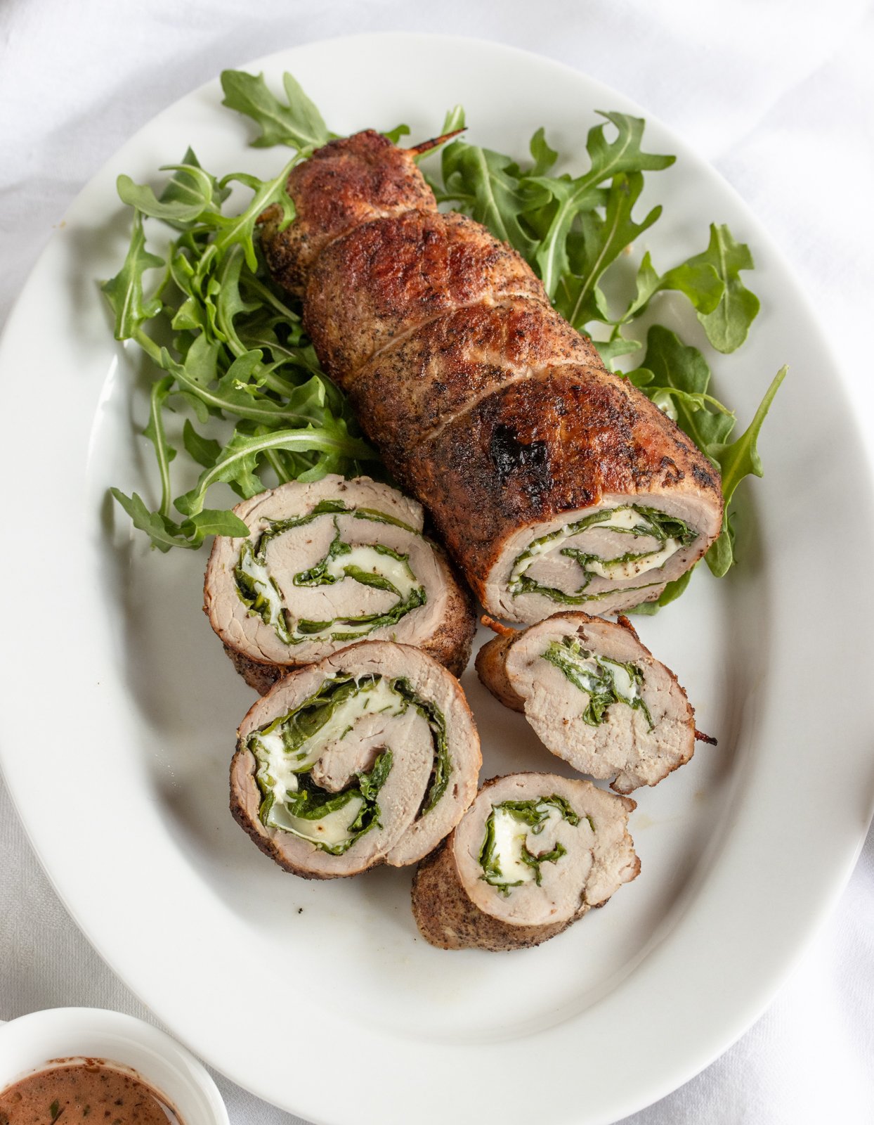 sliced stuffed pork tenderloin ready to be enjoyed