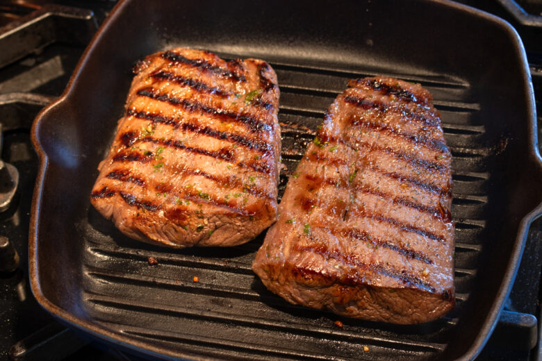 searing the steaks in a grill pan
