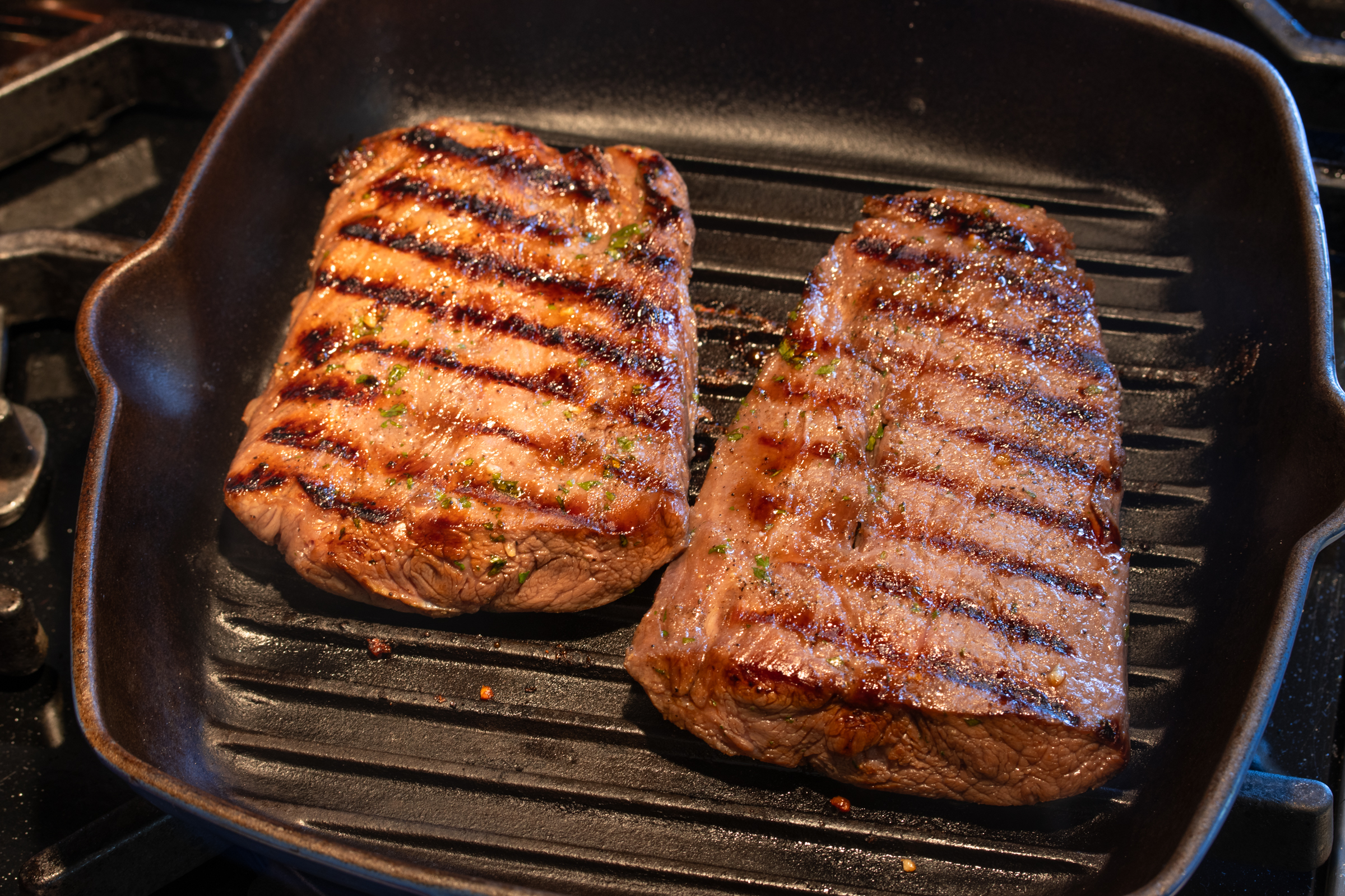 searing the steaks in a grill pan