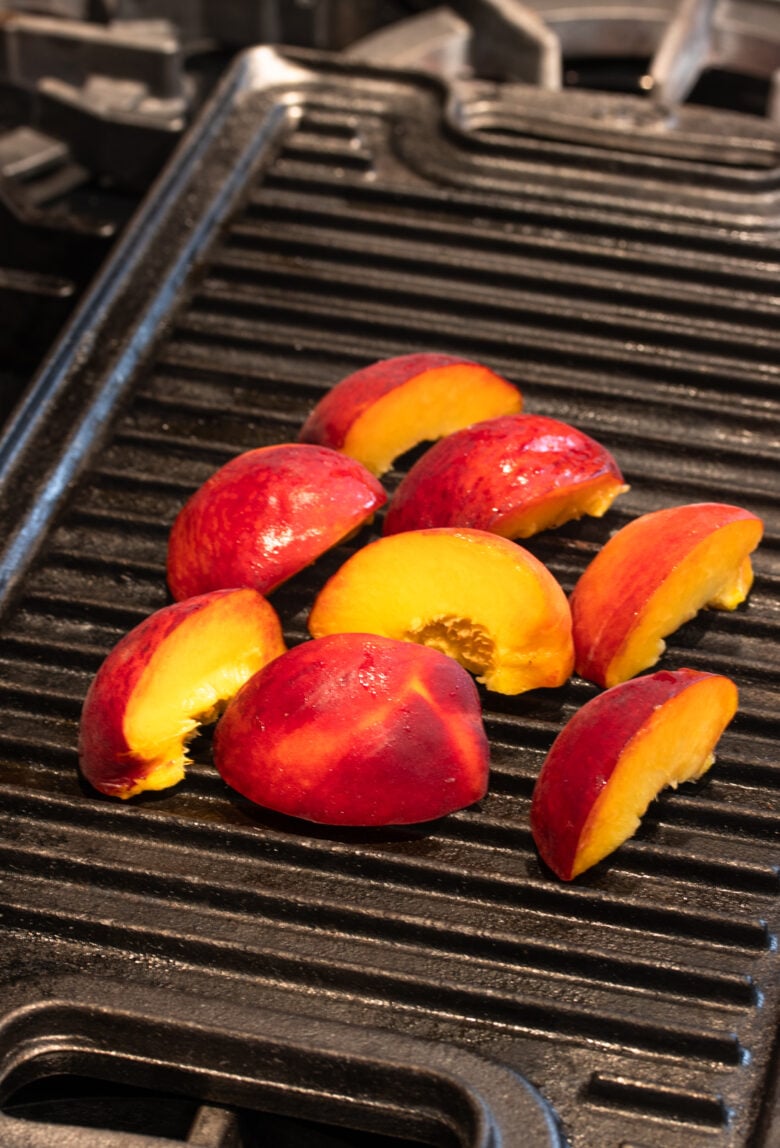 grilling the peaches on a grill pan over the stove
