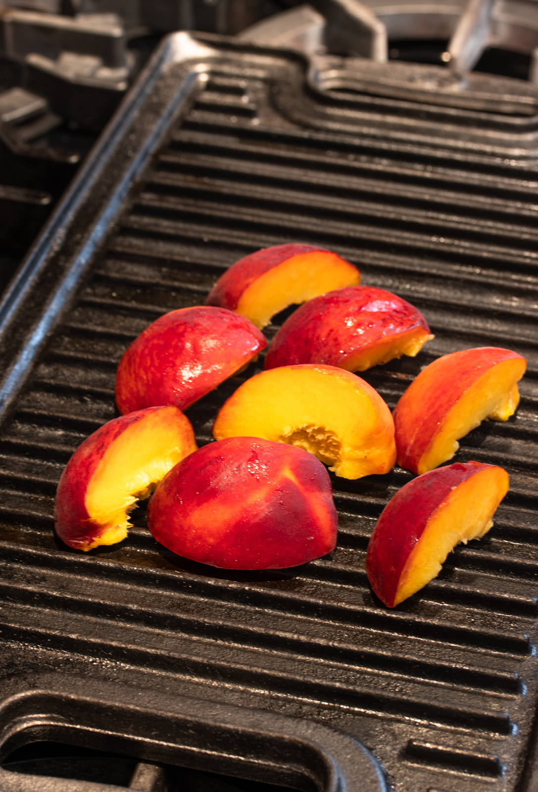 grilling the peaches on a grill pan over the stove