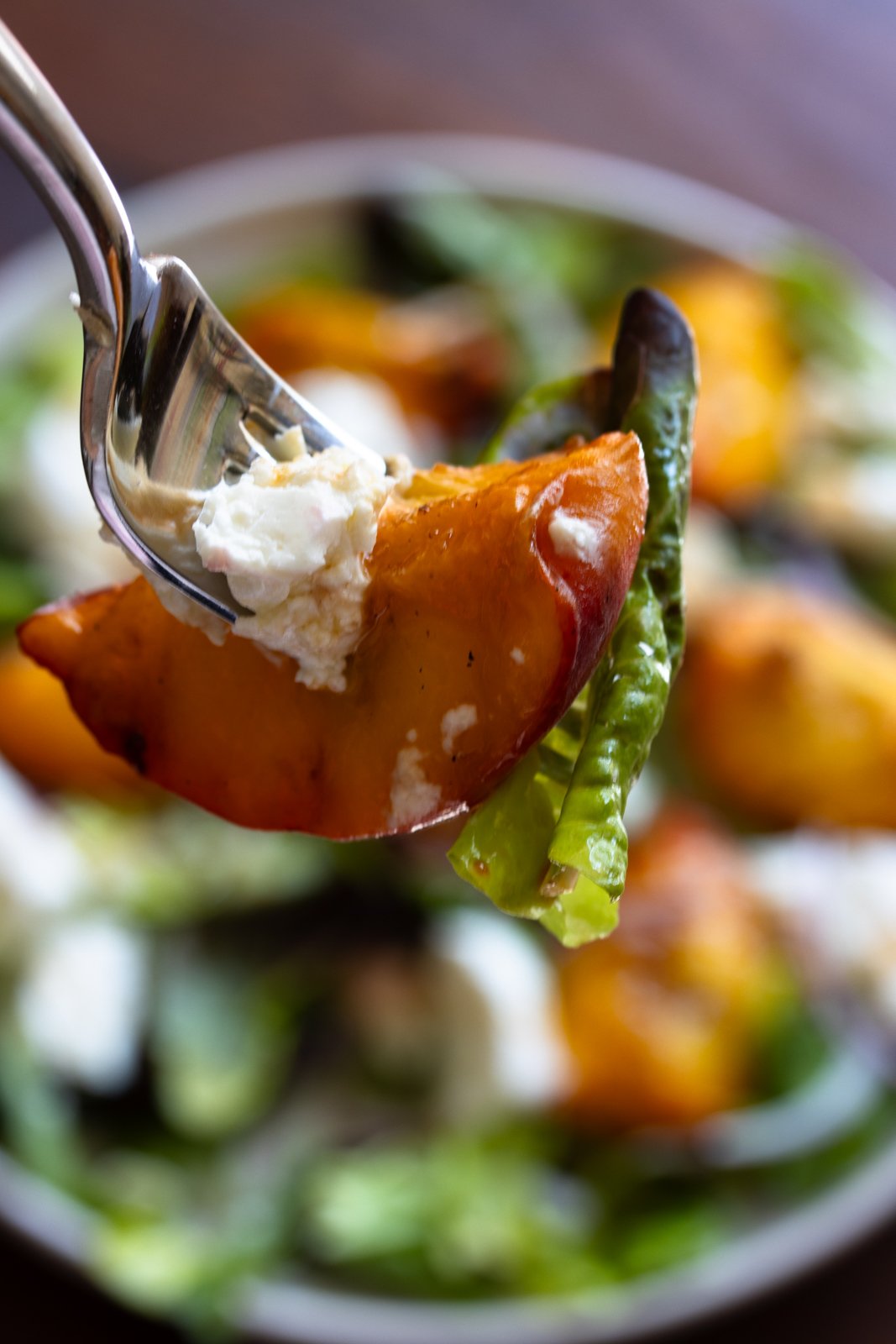 forkful of grilled peach salad