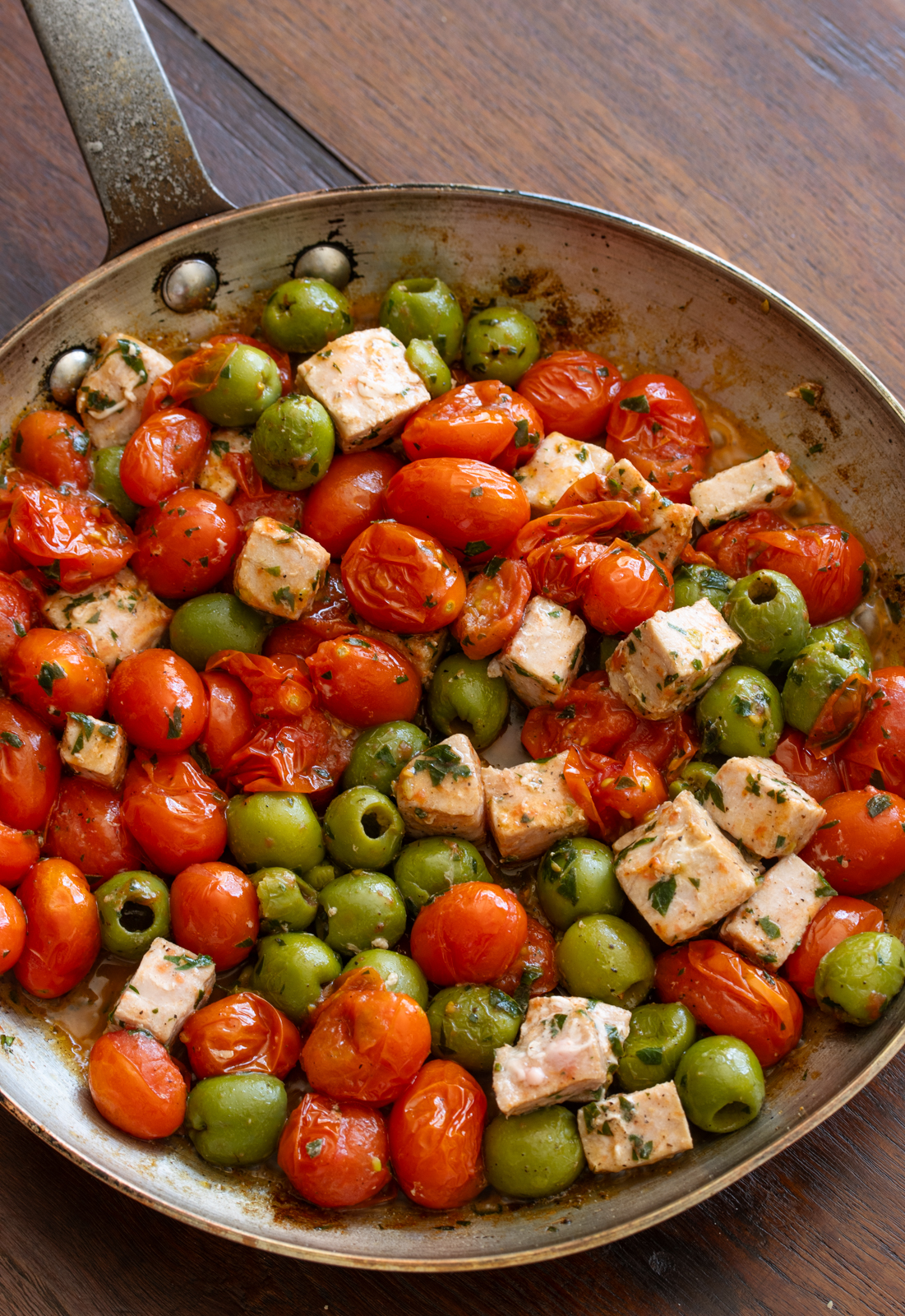 tuna addede to the skillet with the tomatoes and olives