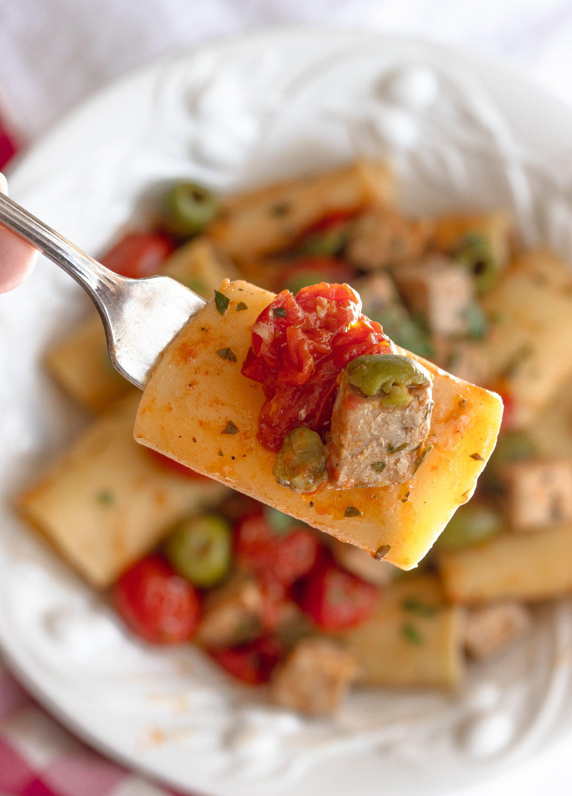a forkful of fresh tuna with paccheri pasta