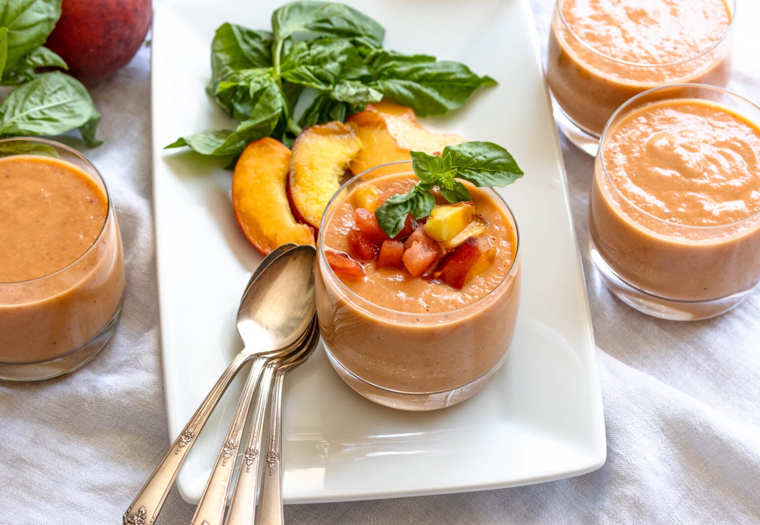 peach, tomato gazpacho served into glasses 