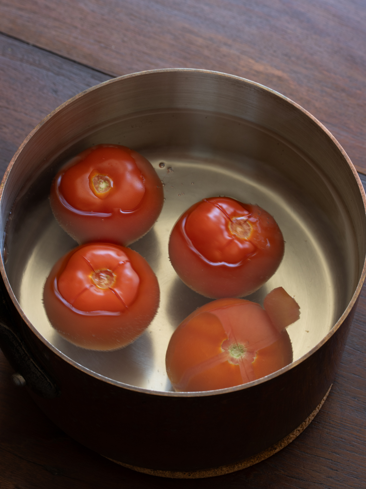 tomatoes being blanched to remove the skin