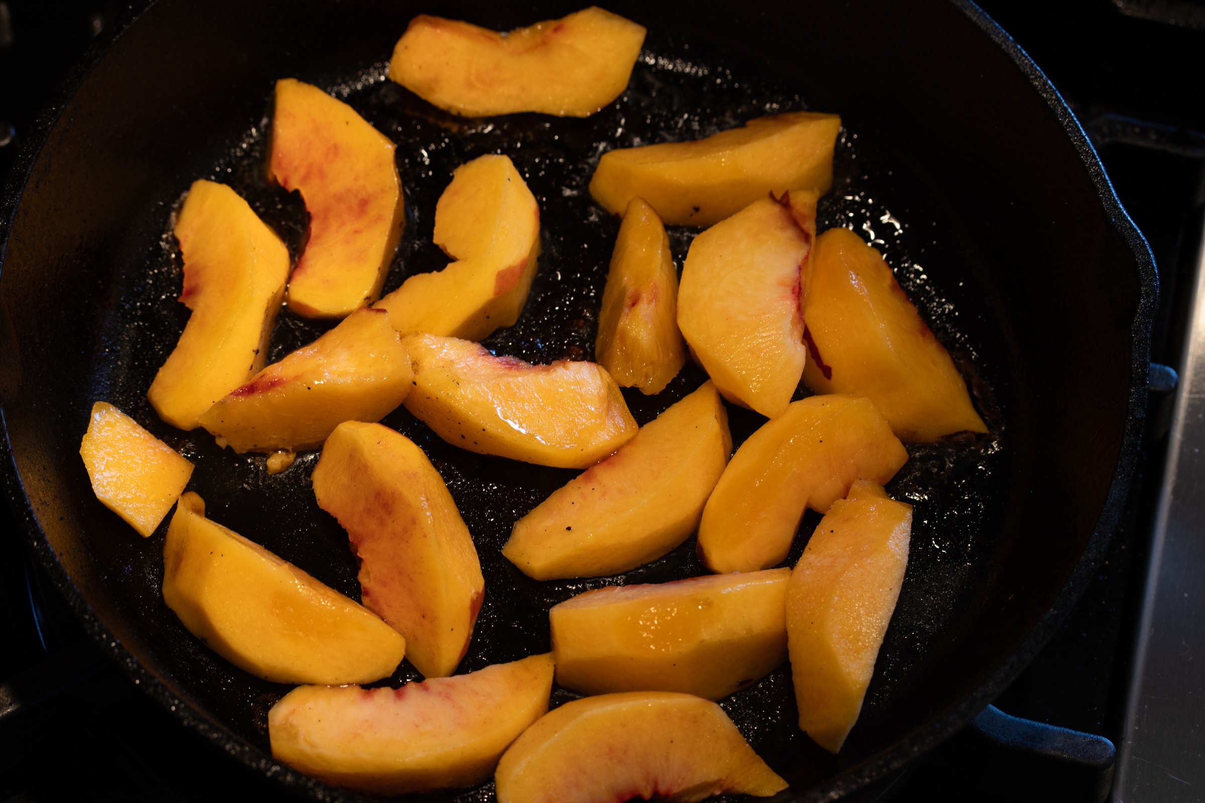 Peaches added to the skillet to create the peach glaze that will be poured over the pork tenderloin.