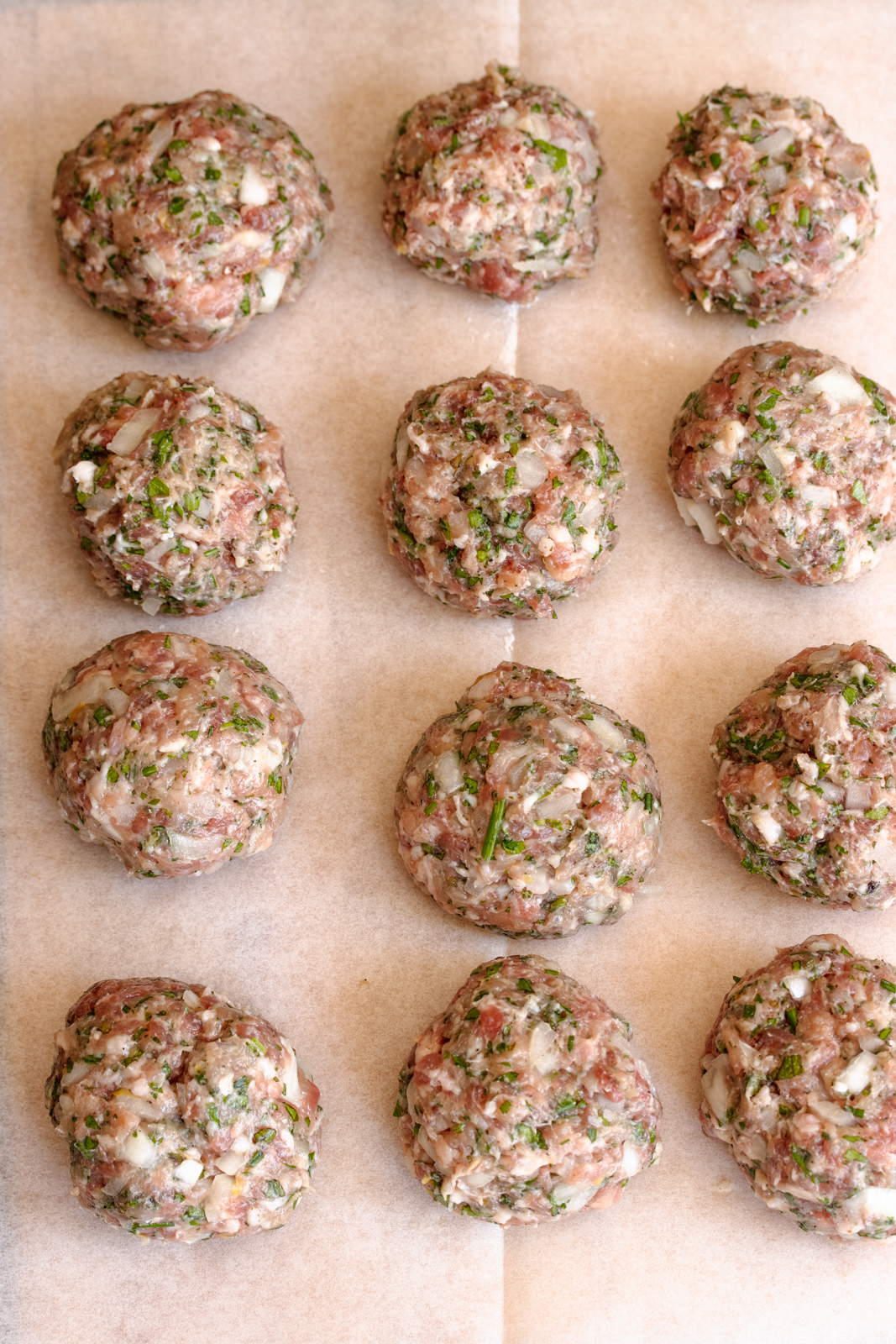 Chicken meatballs are all prepared and ready to be cooked. 