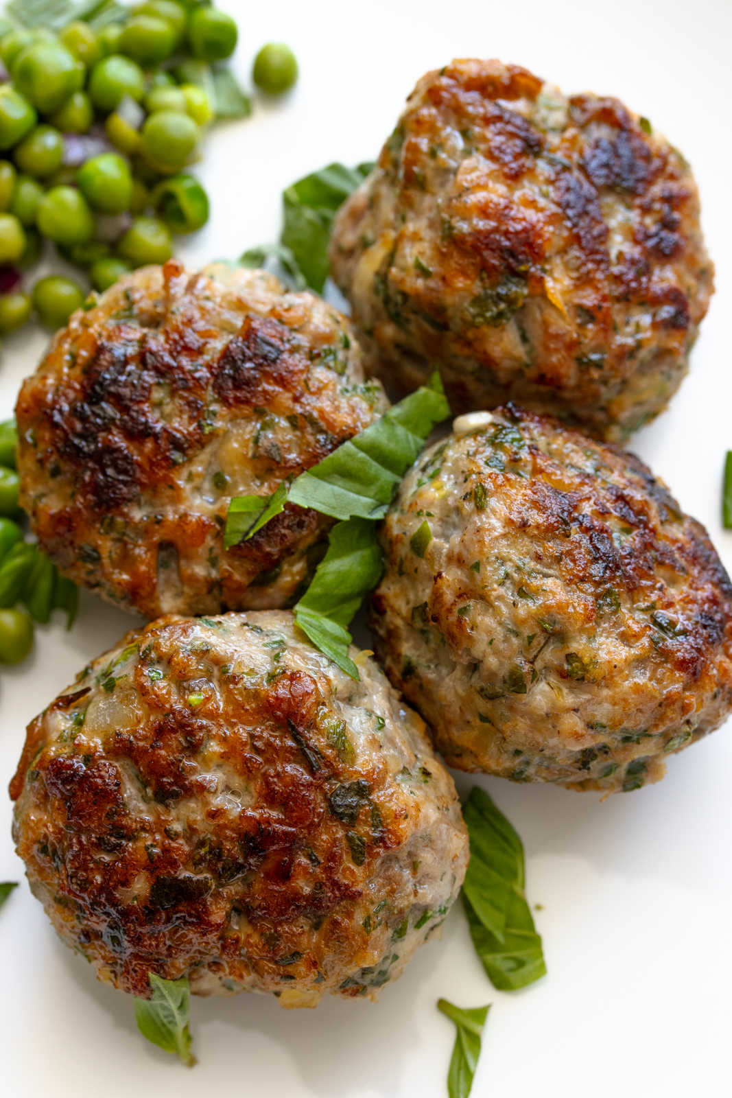 Four ground chicken. meatballs in a serving plate
