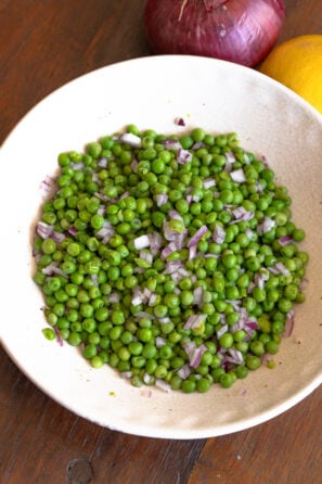 Cold pea salad served in a plate and ready to be enjoyed.