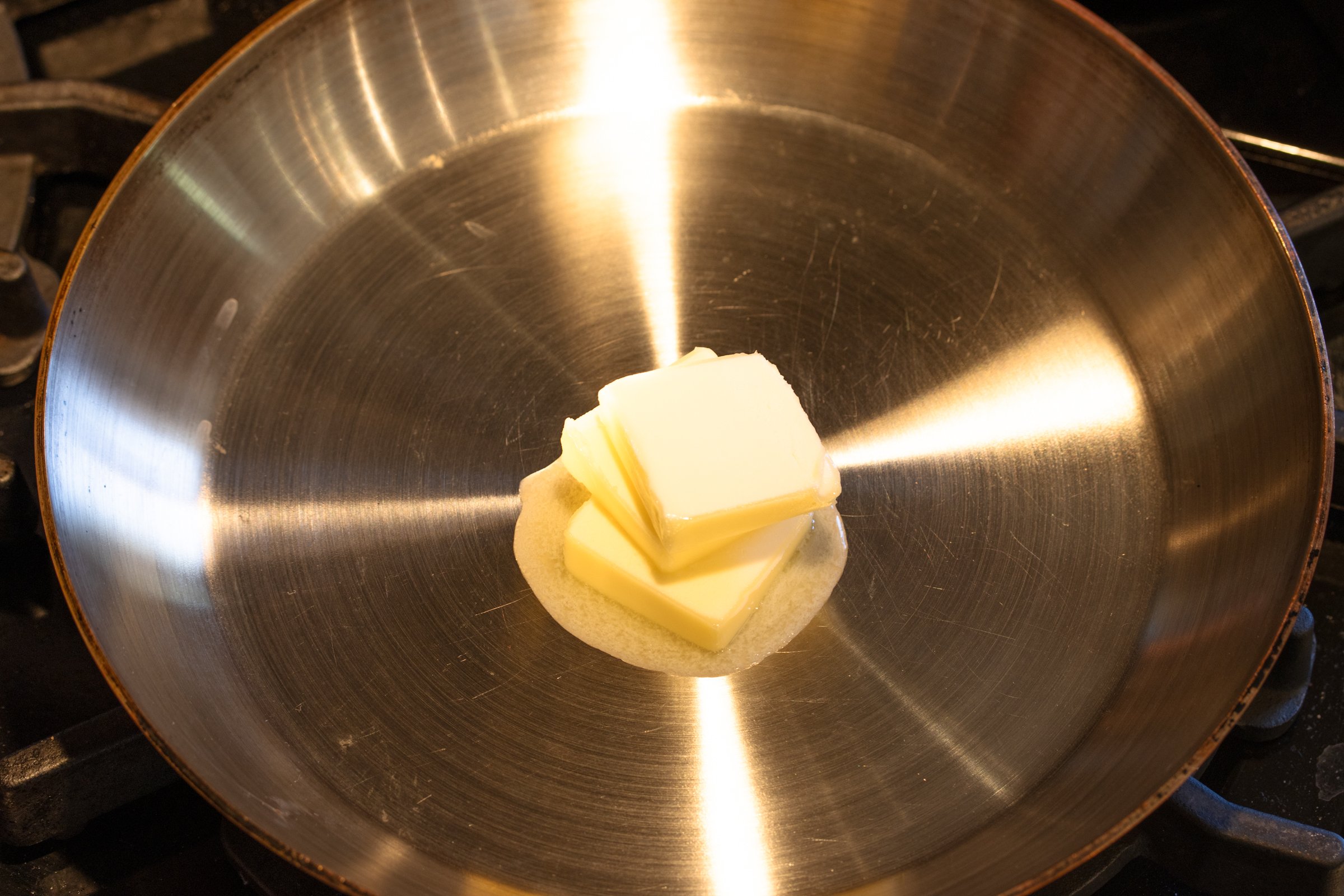 Butter melting in skillet.