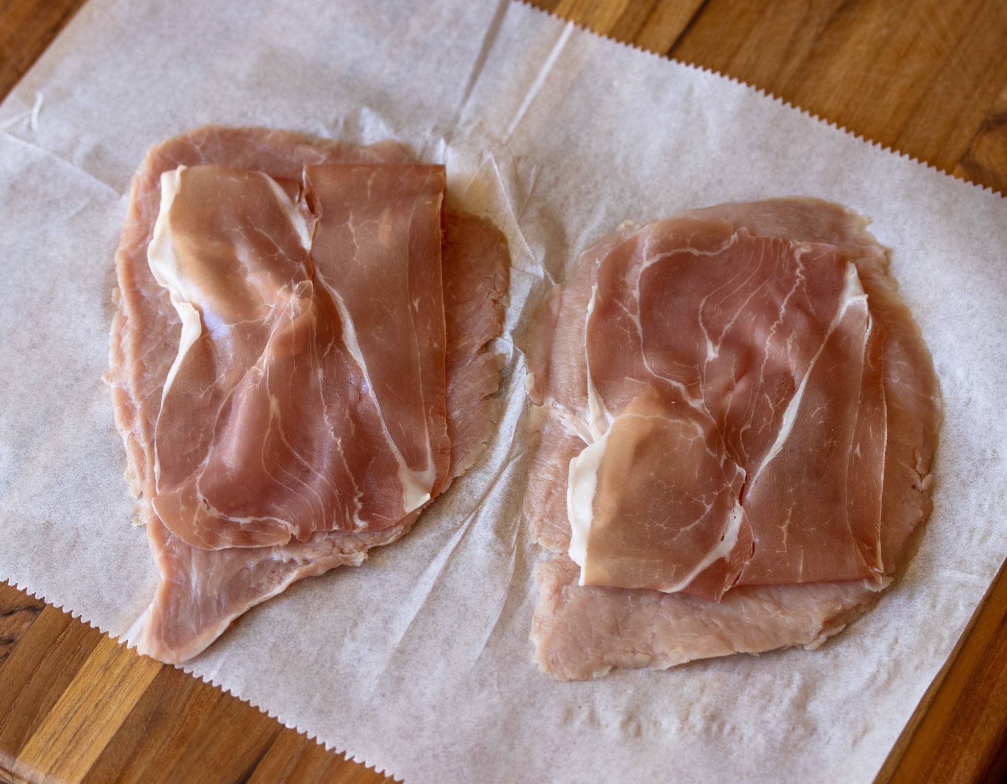 Veal cutlet with prosciutto over it.
