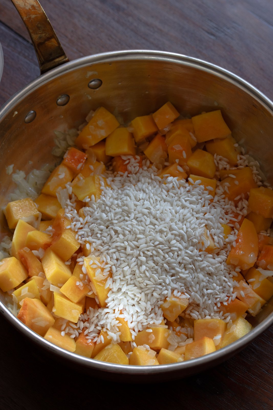 Arborio rice added to the squash and onions.