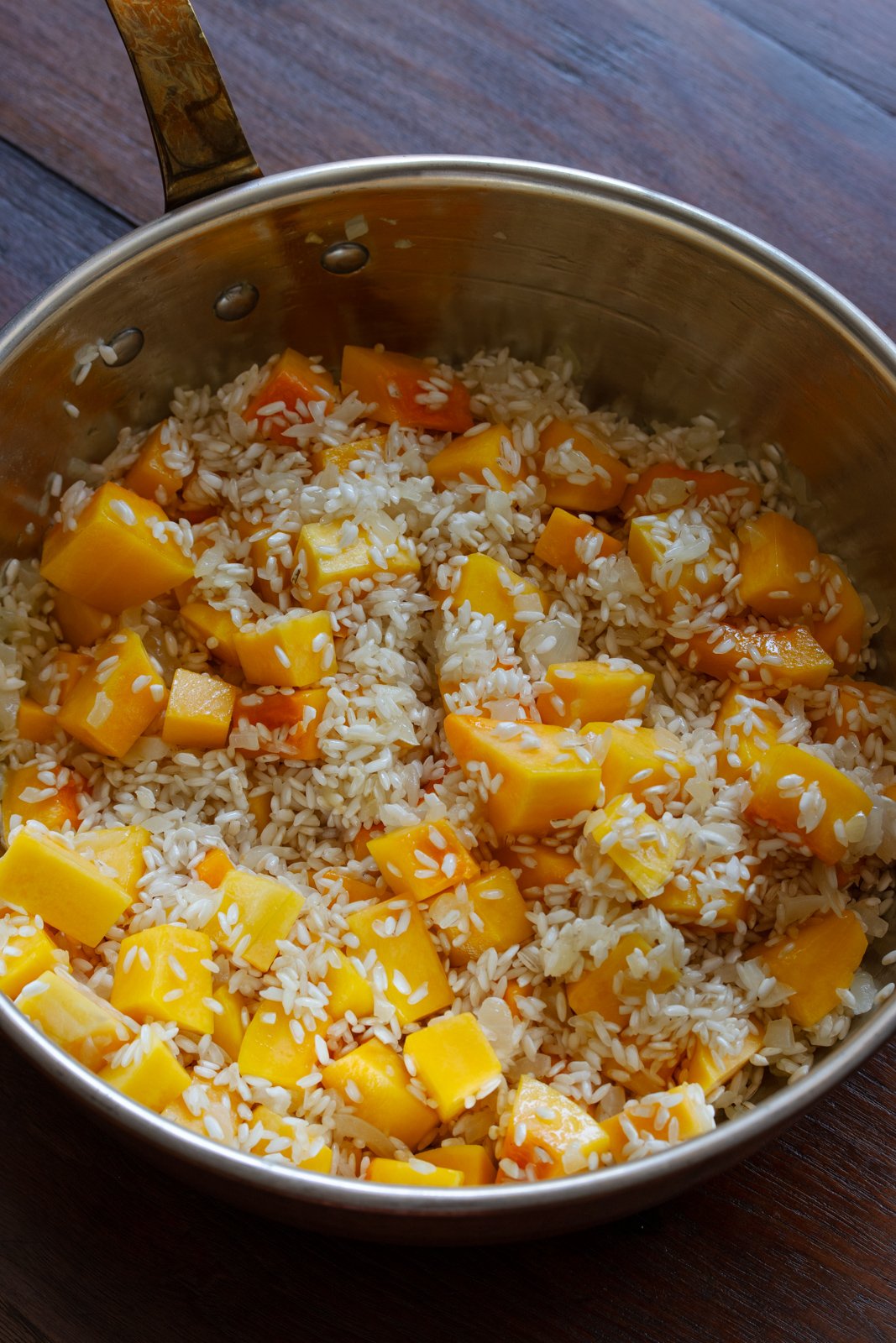 Rice, squash and onion during the cooking process.