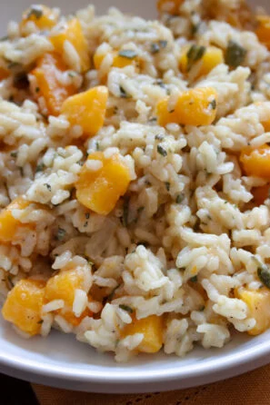 Butternut squash risotto served in a white serving dish