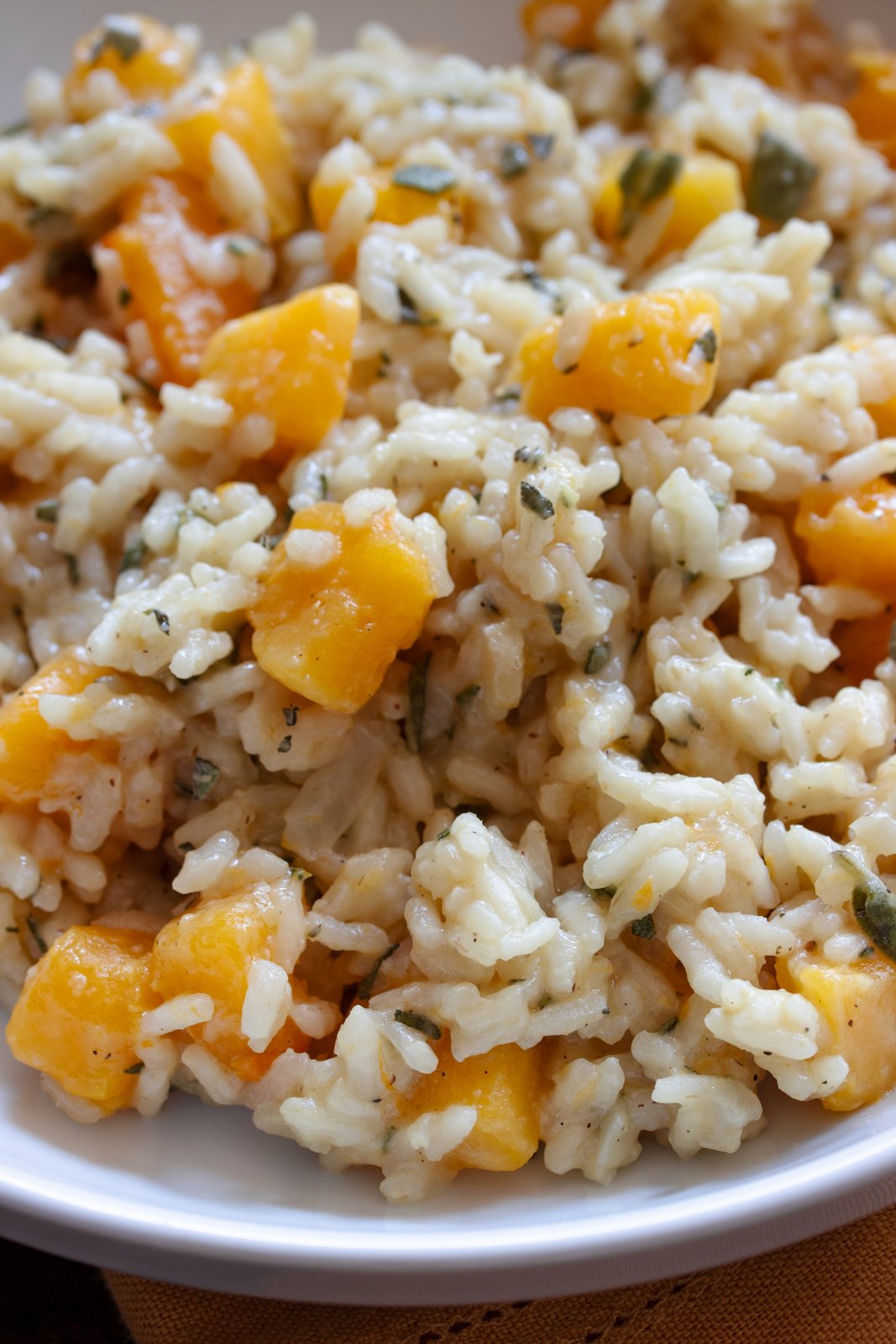 Butternut squash risotto served in a white serving dish